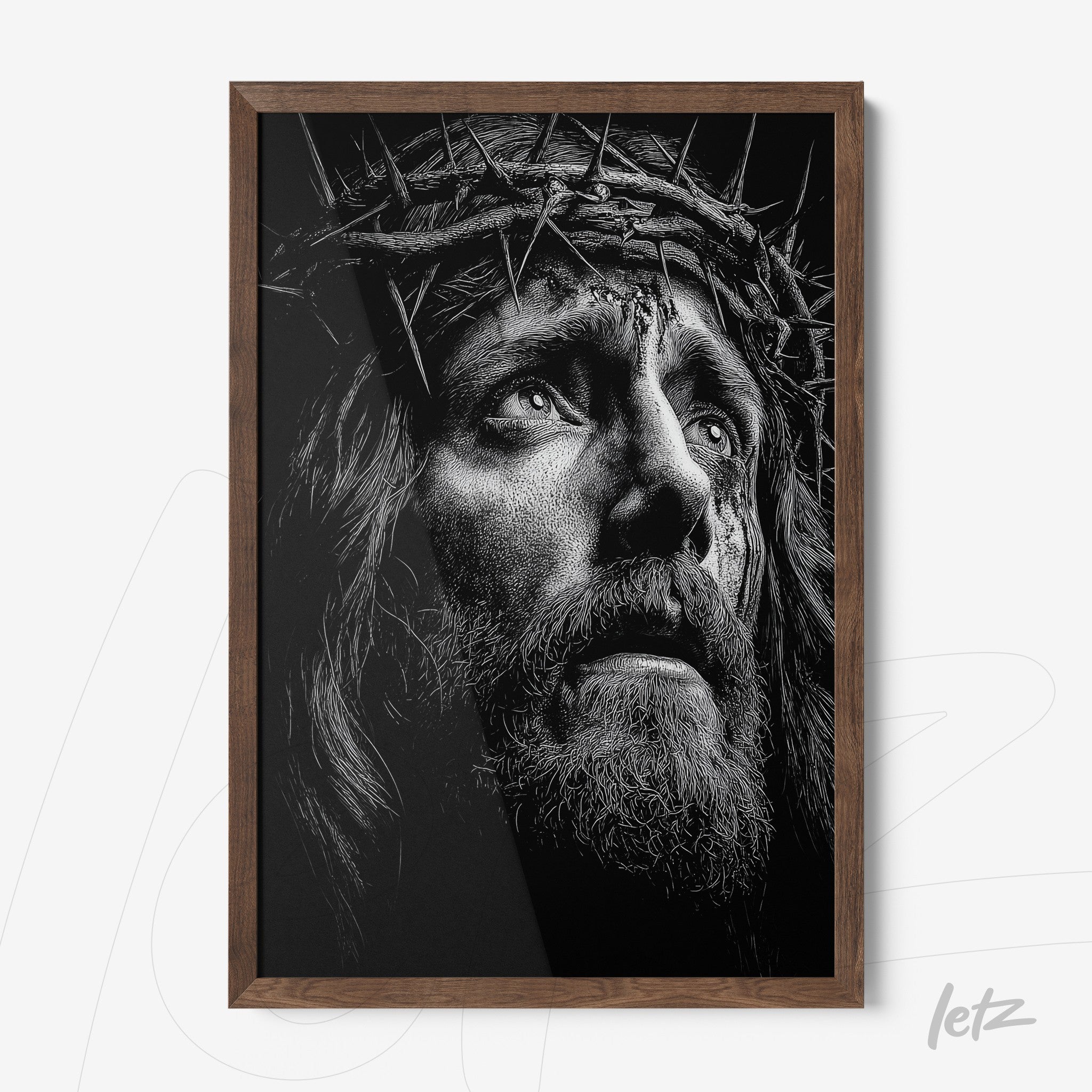 framed black and white portrait of a man wearing a crown of thorns with dark wood frame