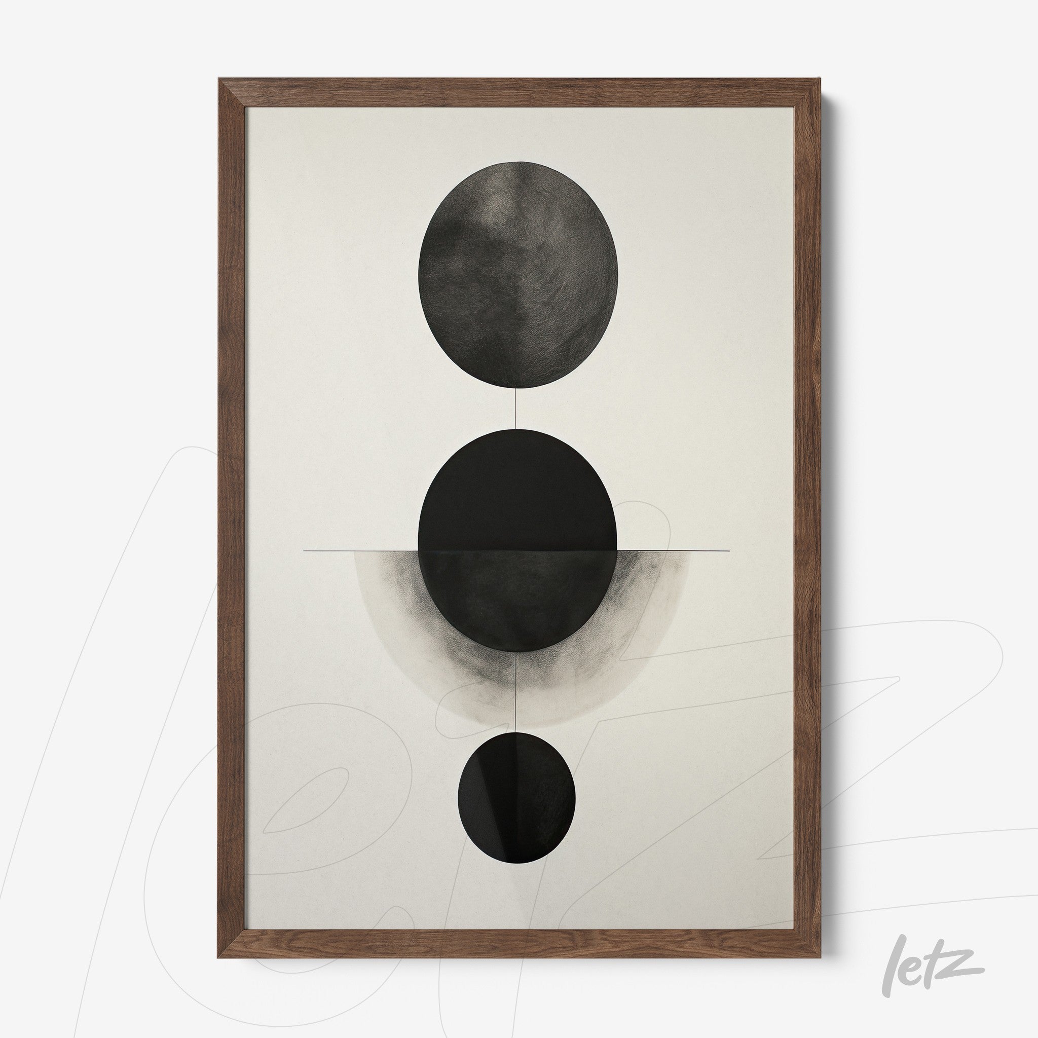 abstract wall art featuring black and white circular shapes highlighted, framed in dark wood
