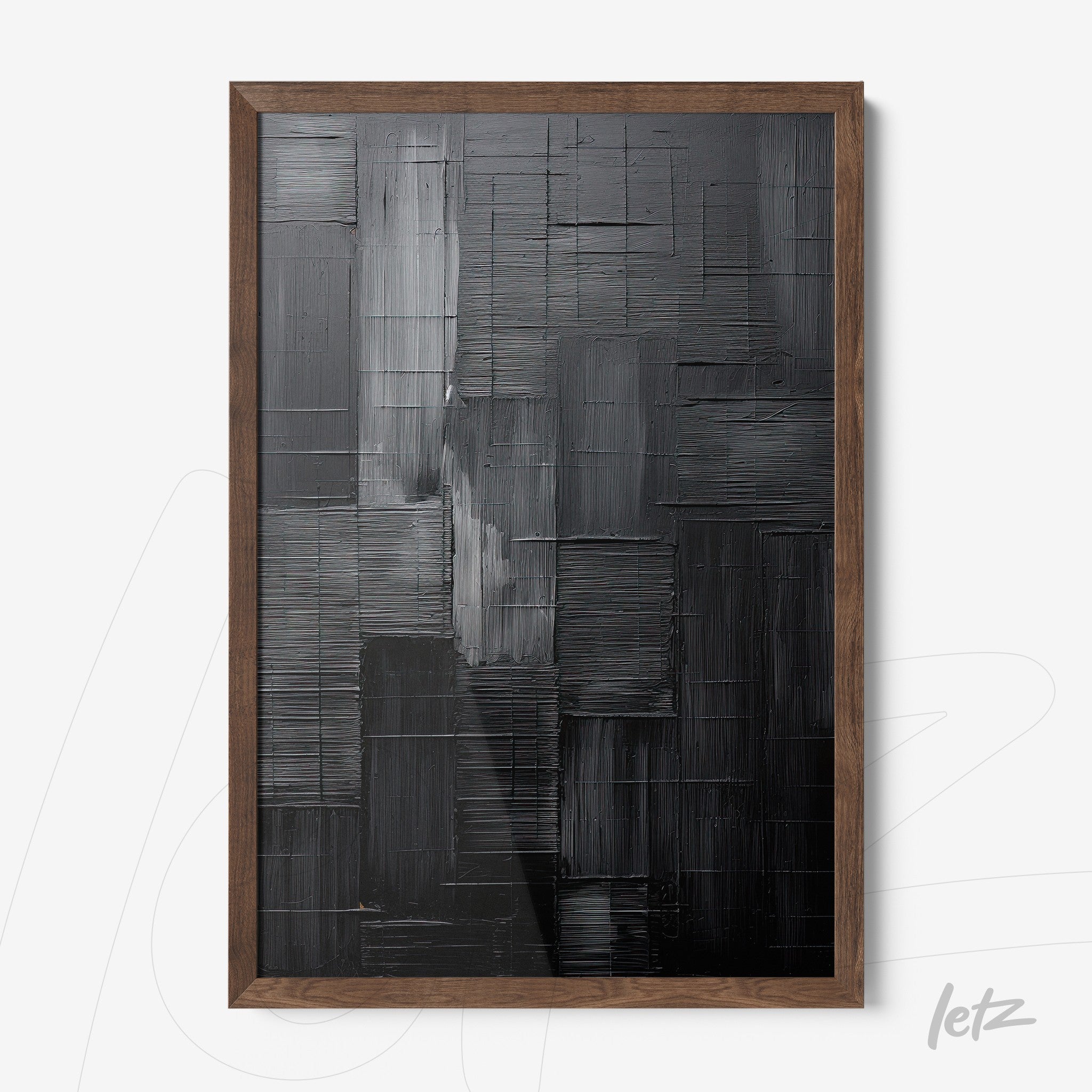 abstract wall art in shades of black and gray with bold texture, framed in dark wood frame