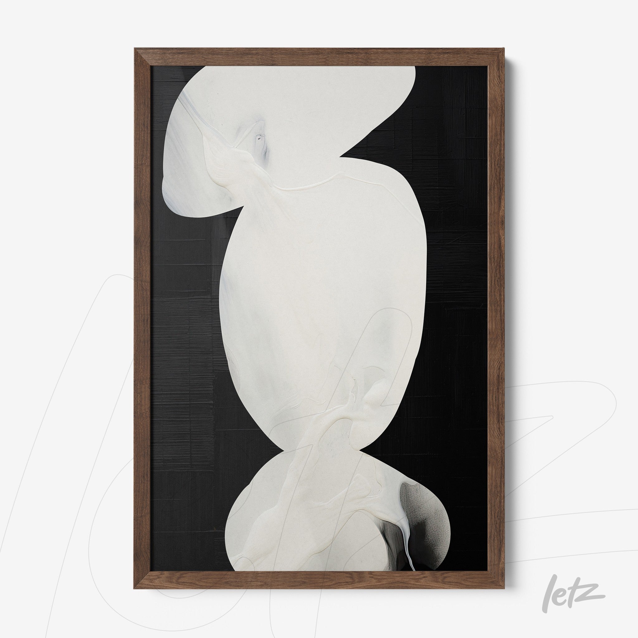 framed abstract art in light tones against a black background with a dark wood frame