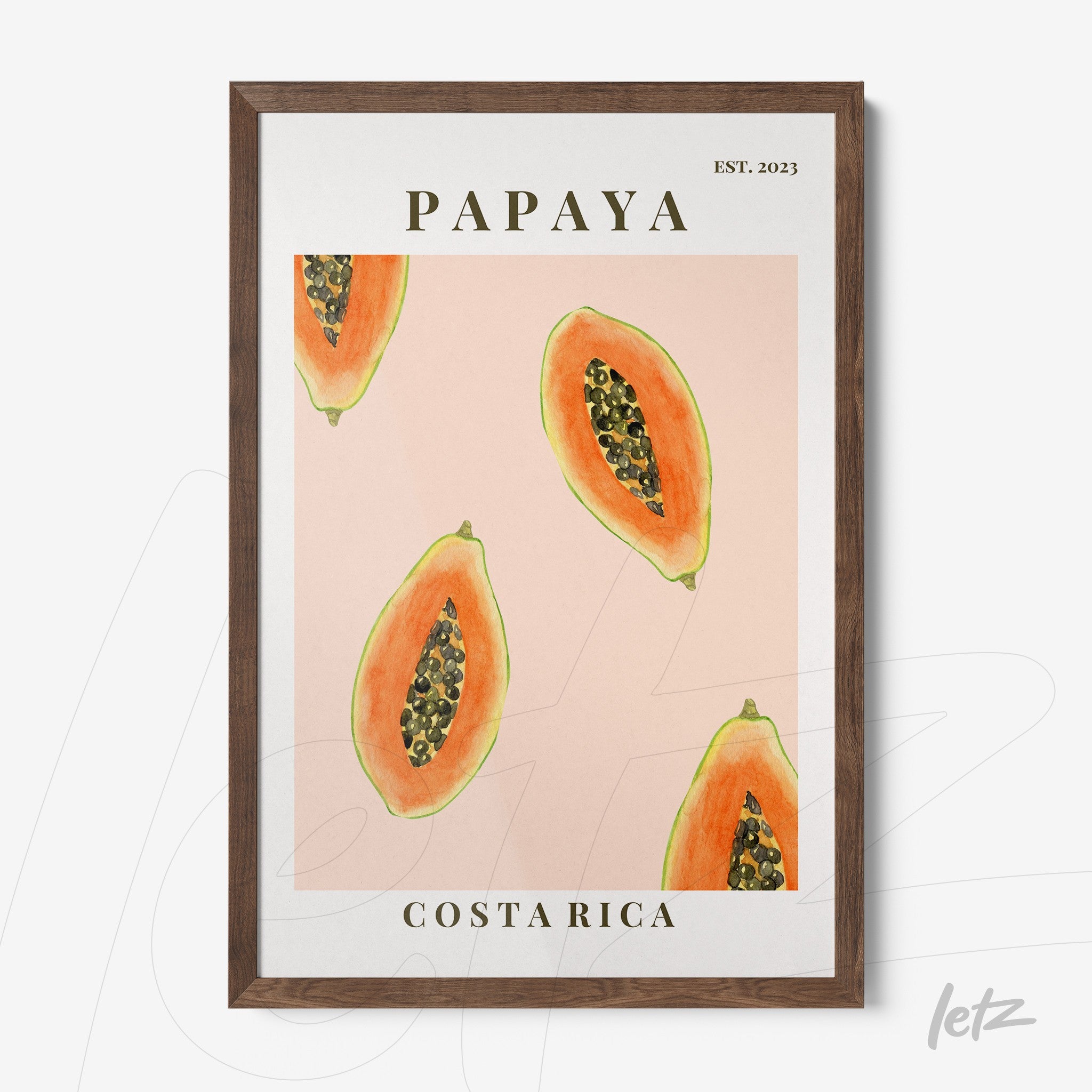 framed artwork featuring papaya illustrations on a pink background with dark wood frame