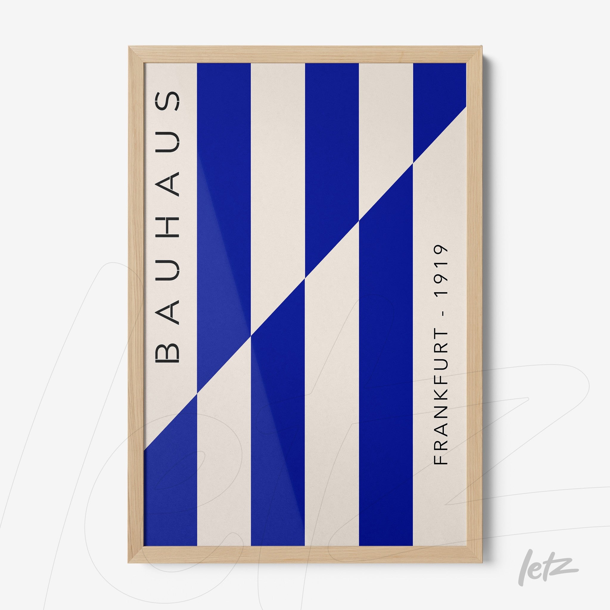 poster with geometric art in blue and white with light wood frame and vertical text reading bauhaus frankfurt 1919