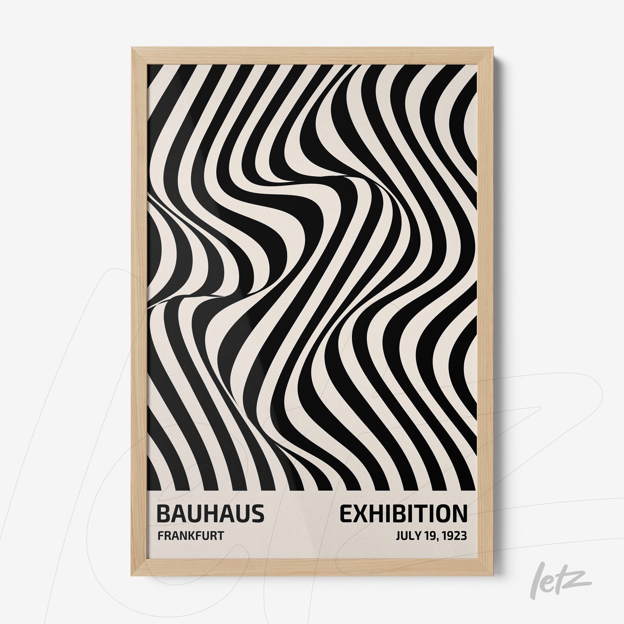poster with black and white abstract design in light wood frame