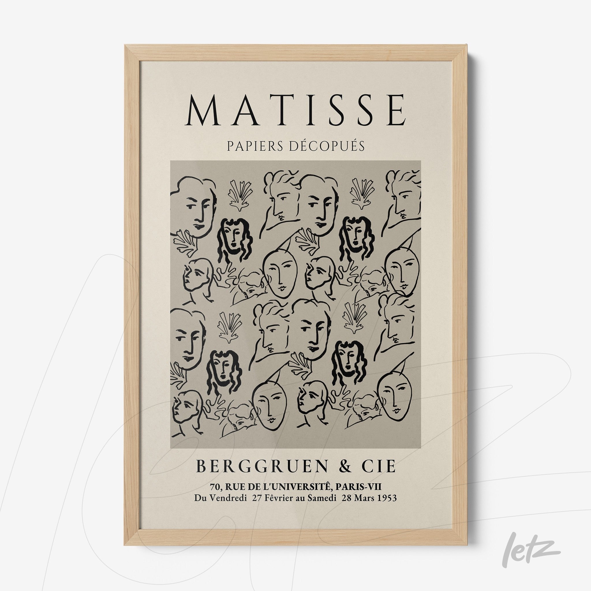framed wall art featuring modern style faces and shapes on a light background with light wood frame