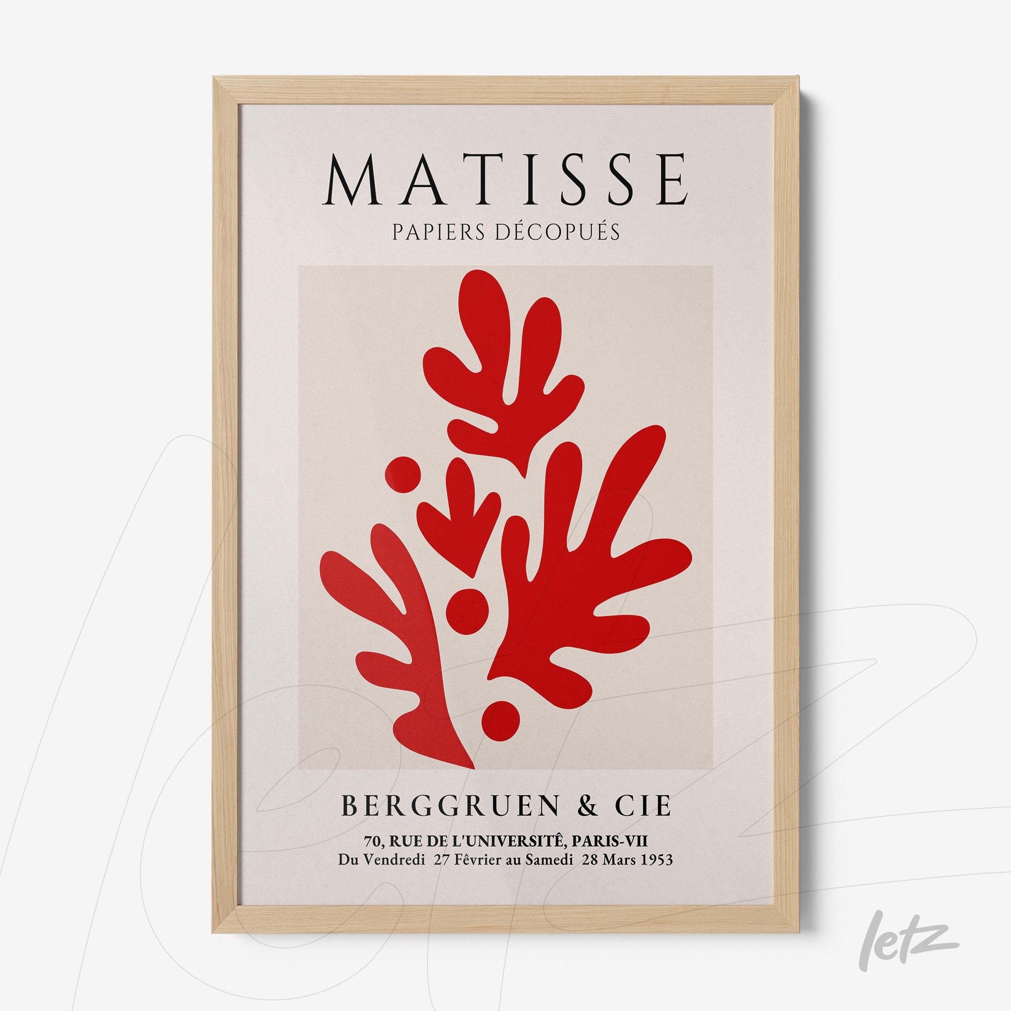 framed artwork featuring red cut-out shapes inspired by Matisse with light wood frame