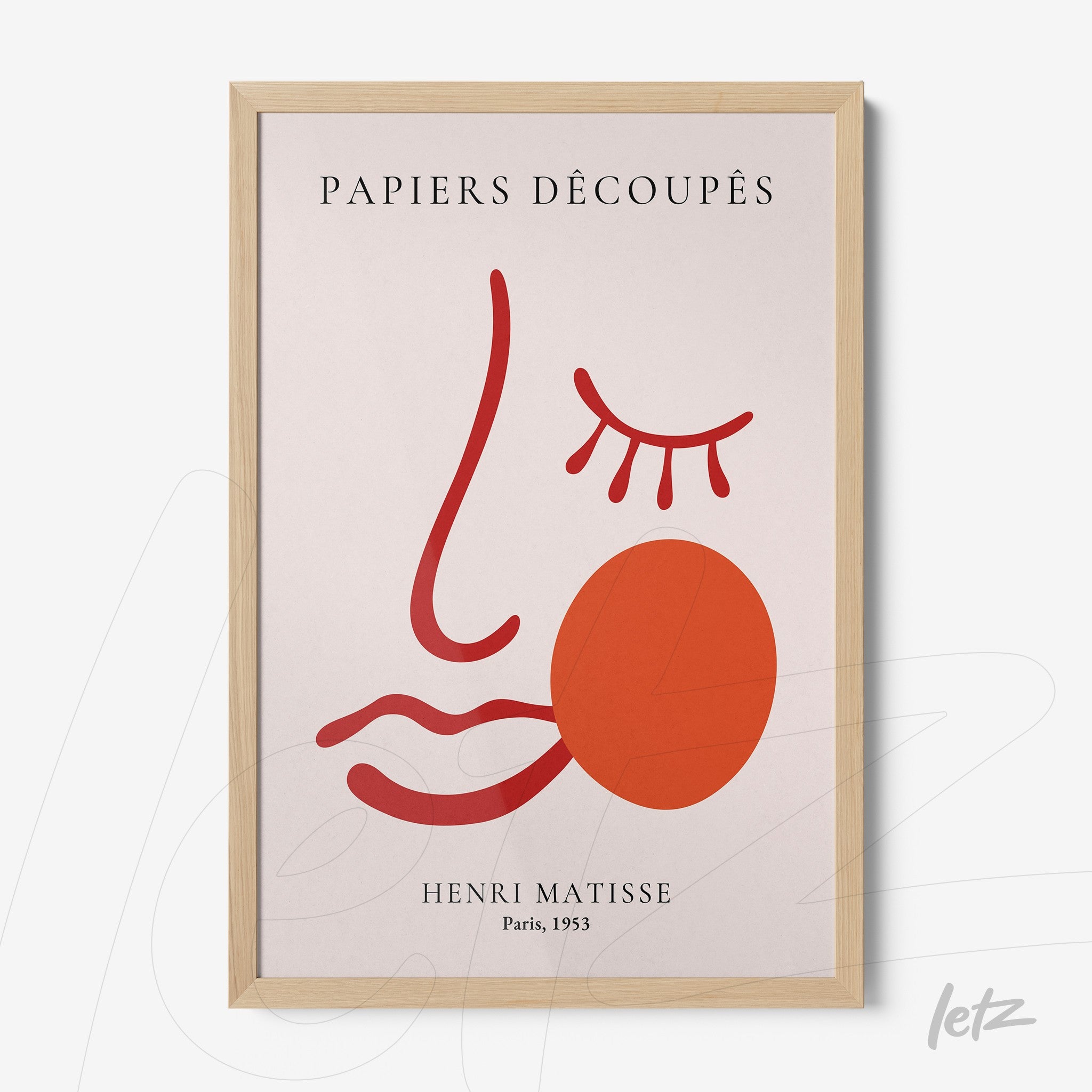 framed abstract art featuring a stylized face in red and orange tones with a light wood frame