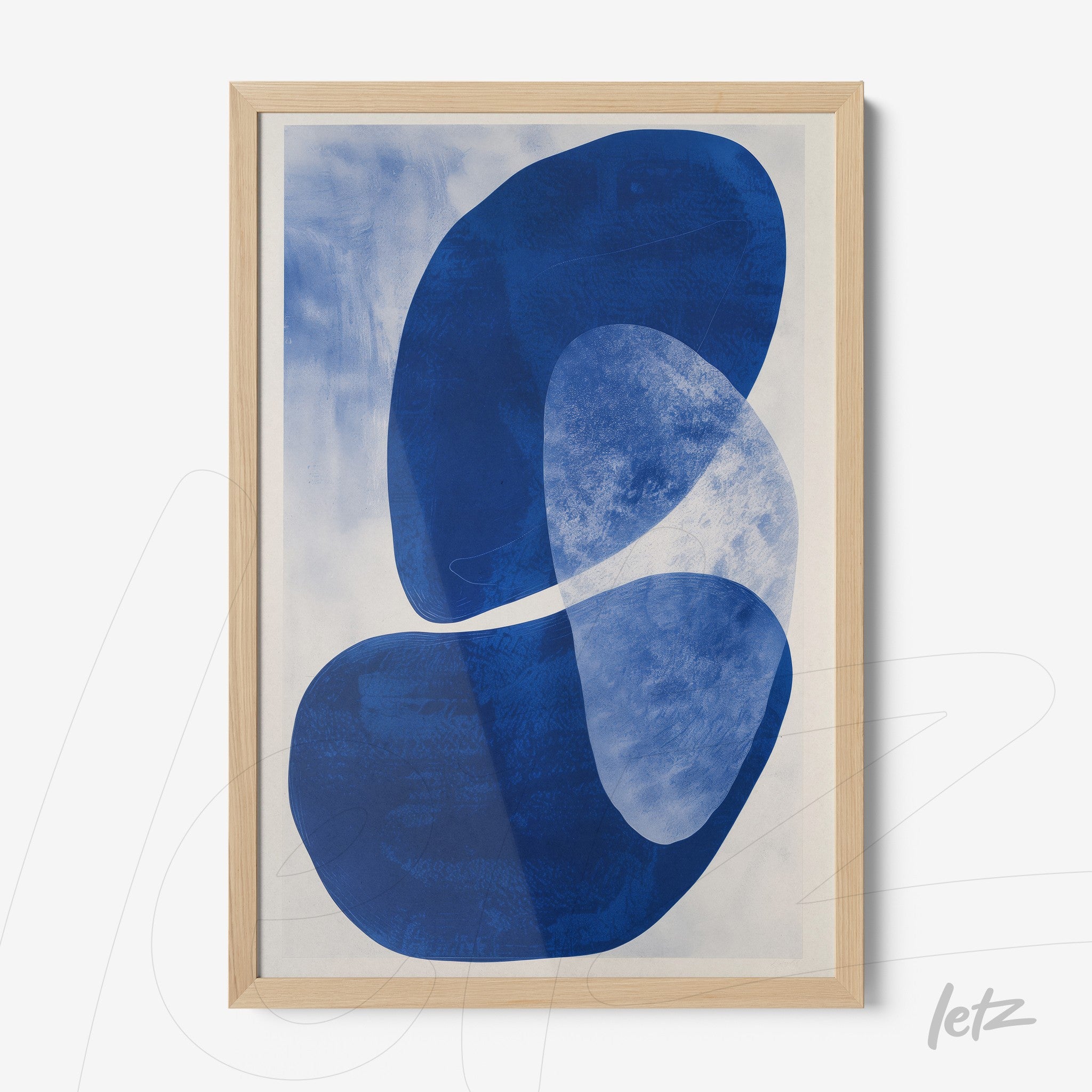 framed abstract wall art in shades of blue with light wood frame