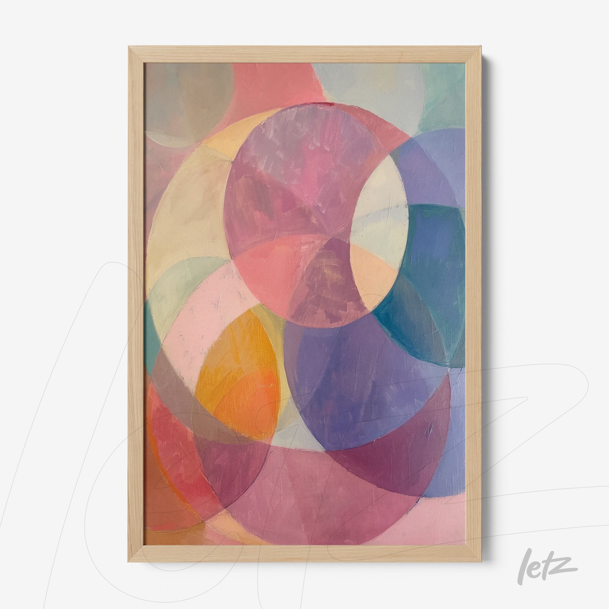 framed artwork featuring colorful abstract circles in a light wood frame