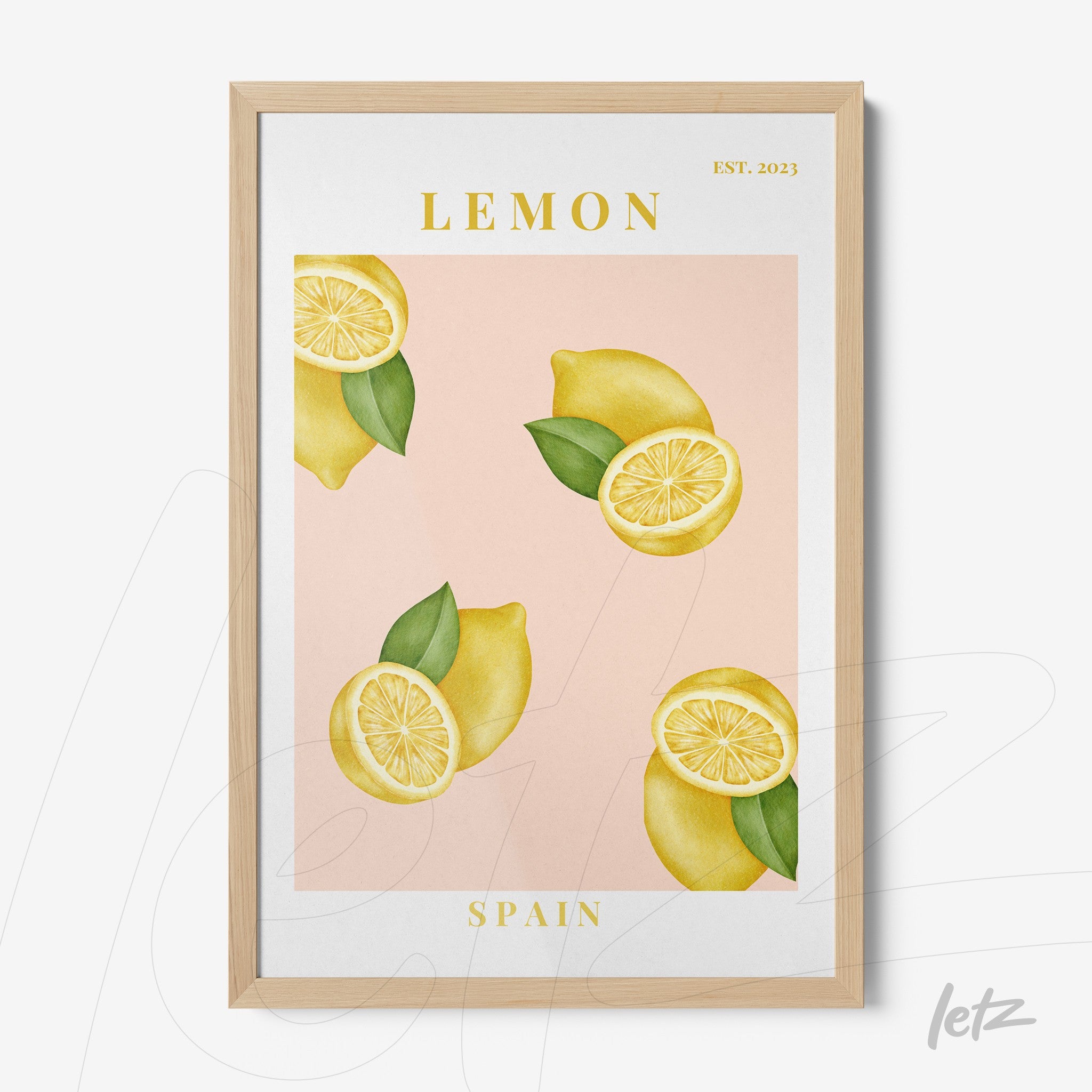 framed wall art featuring lemons on a pink background with light wood frame