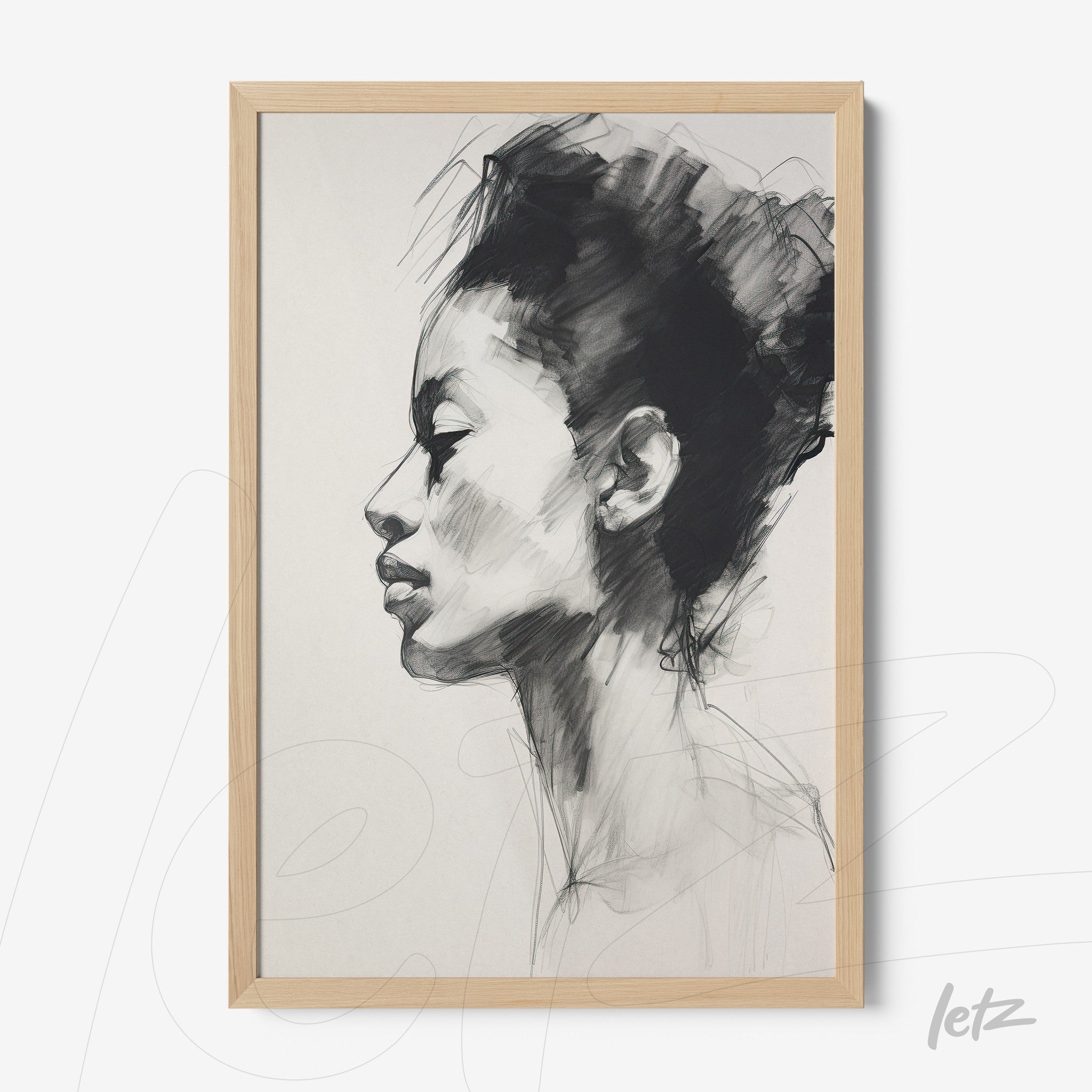 framed artwork featuring a black and white sketch of a woman's profile with light wood frame