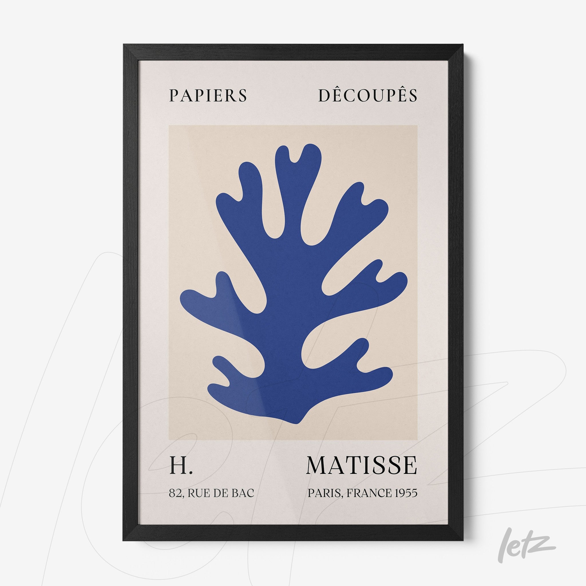 framed modern art featuring a blue coral shape on a light background with sleek black frame