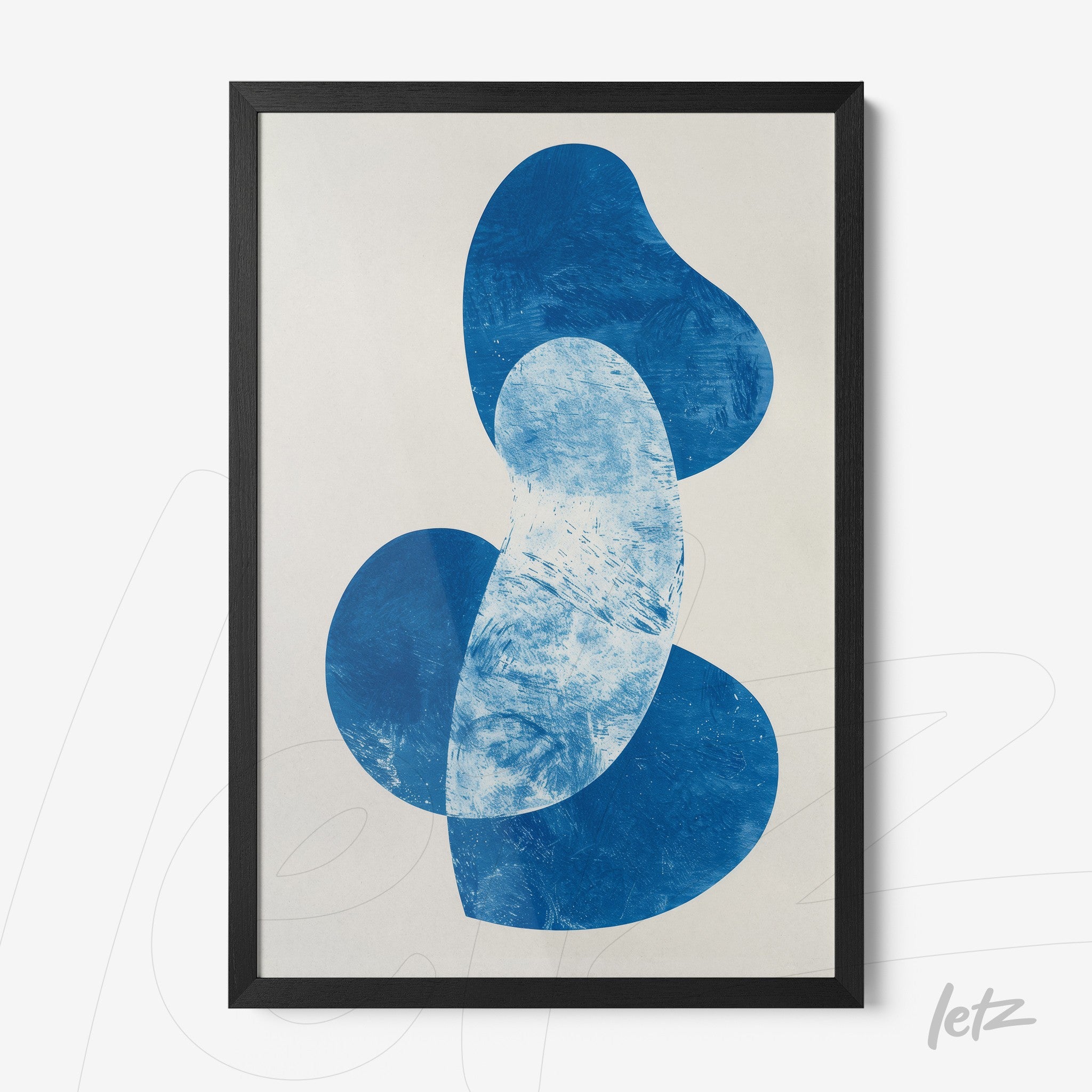 framed abstract art in shades of blue on light background with black frame