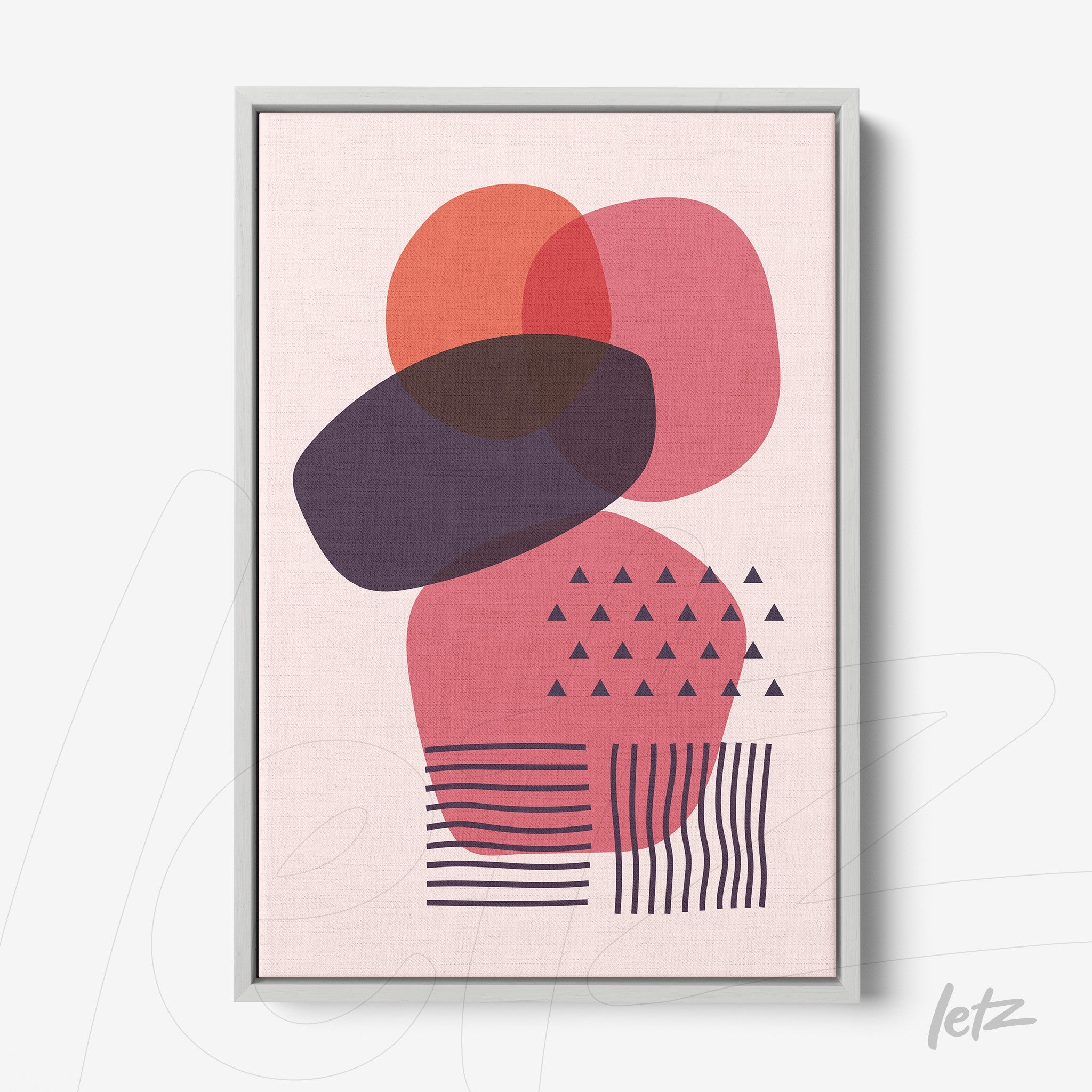 framed abstract art with overlapping geometric shapes in shades of pink and red, light gray frame