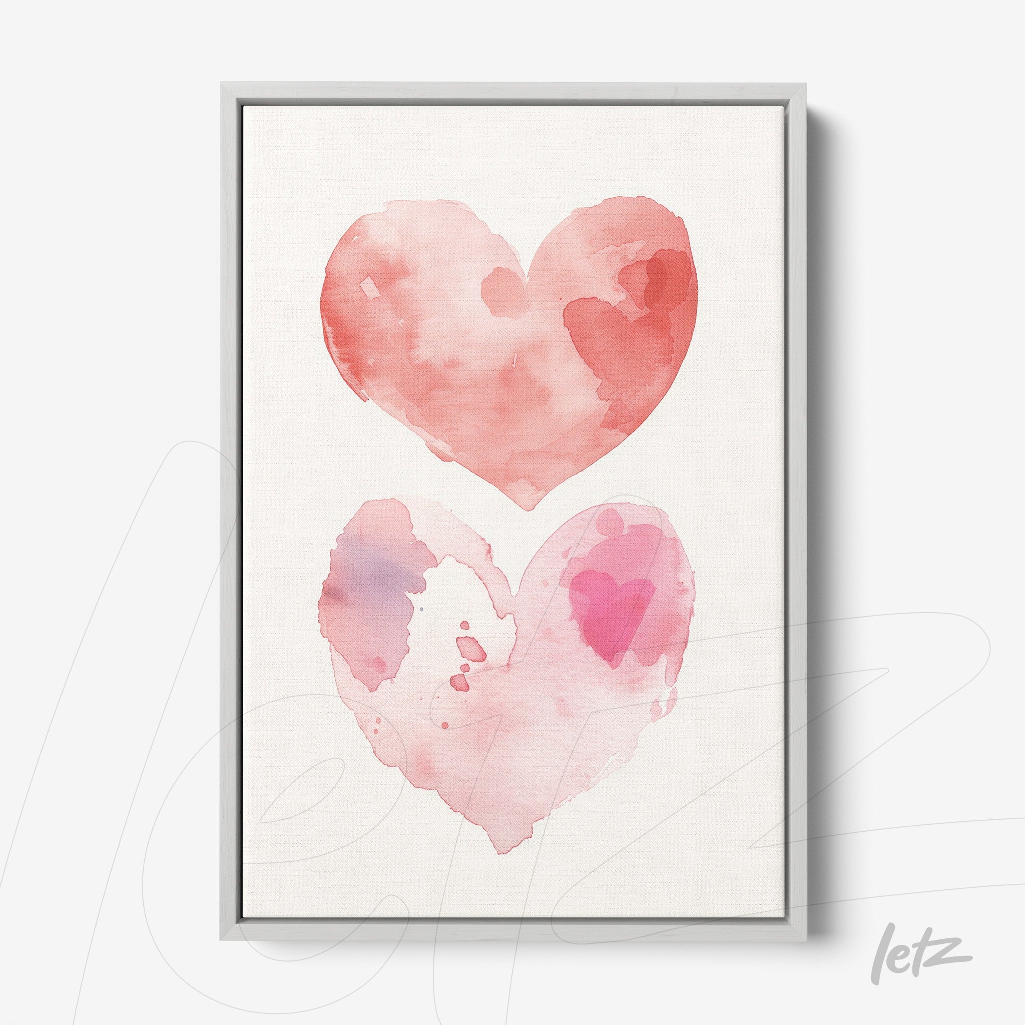framed wall art featuring watercolor hearts in shades of pink with light gray frame