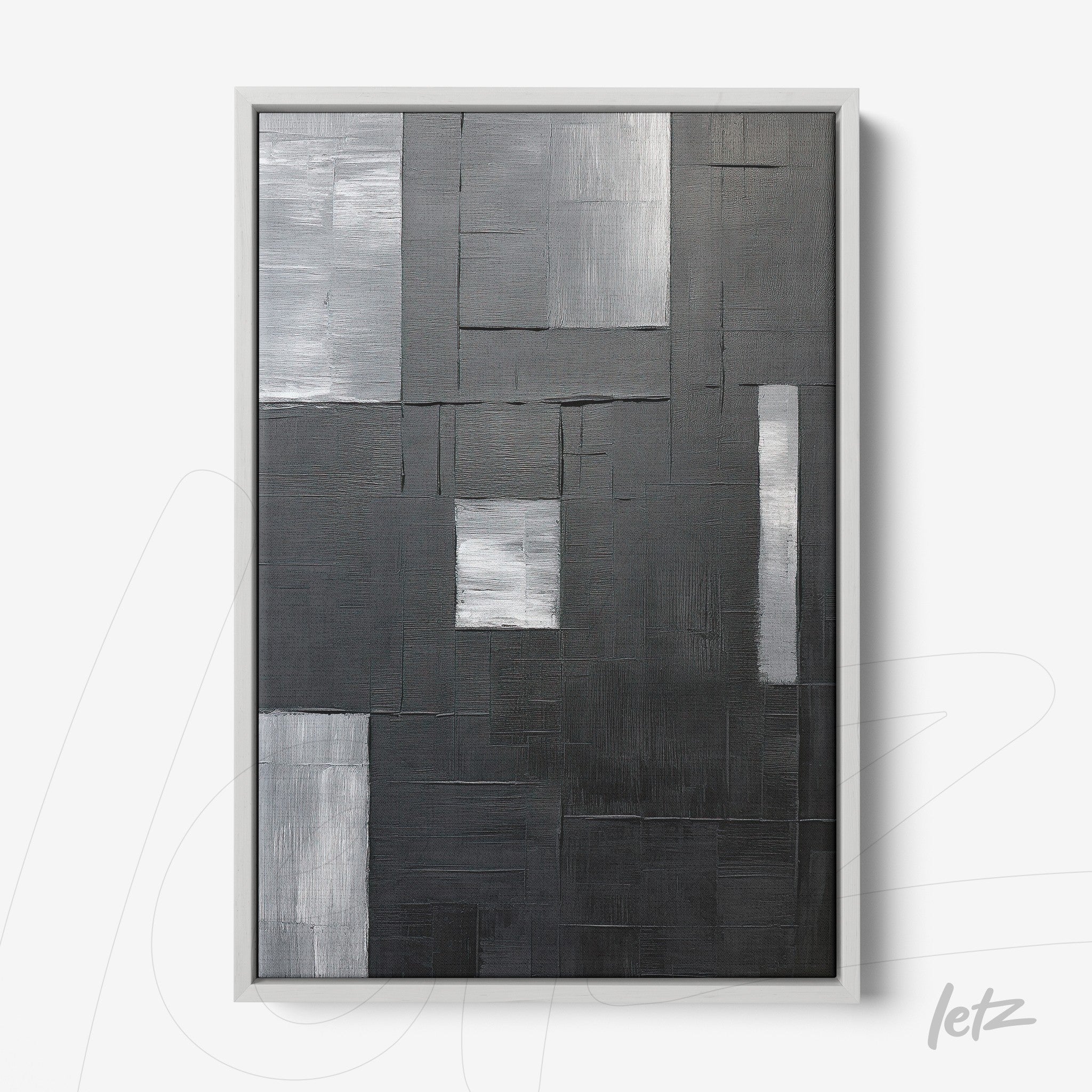 abstract wall art in shades of gray and black with textured surface and silver frame