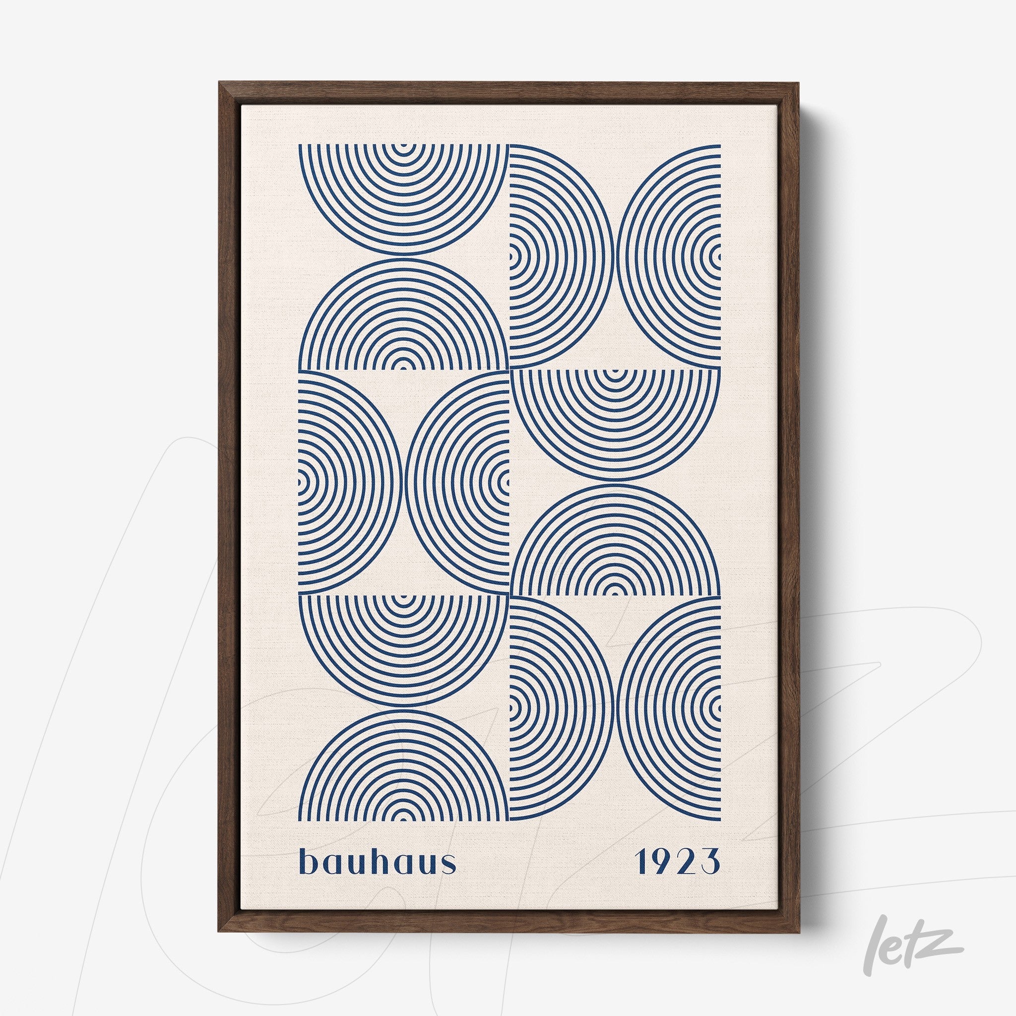 framed art with geometric pattern of concentric blue arcs and text bauhaus 1923 in dark wooden frame