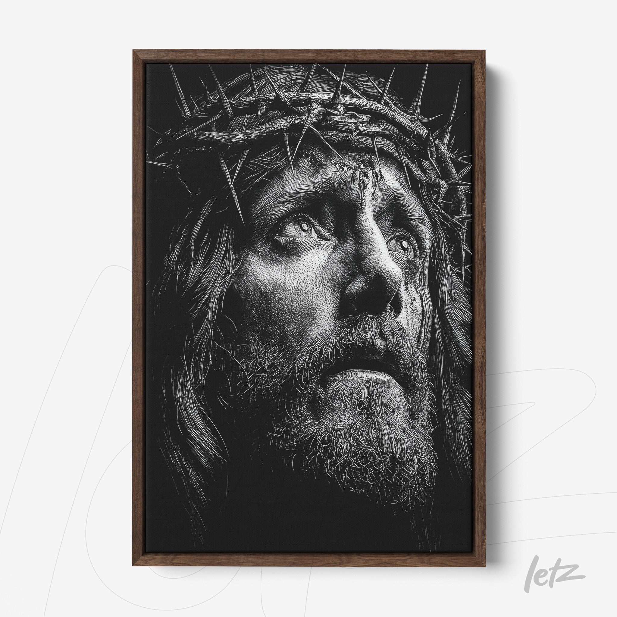 framed wall art in dark wooden frame featuring a black and white portrait of a religious figure wearing a crown of thorns