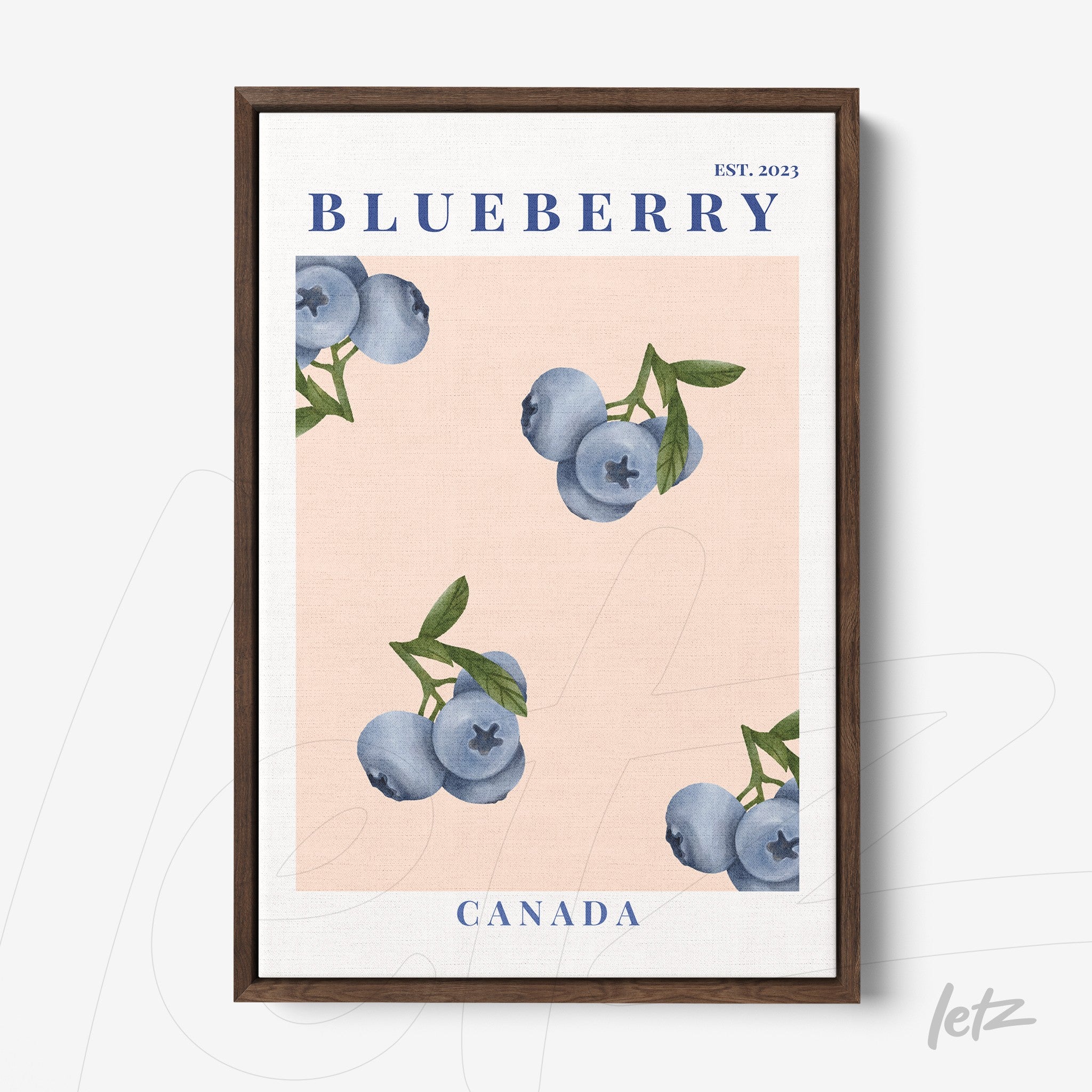 framed wall art featuring blueberries on a light pink background with dark wood frame