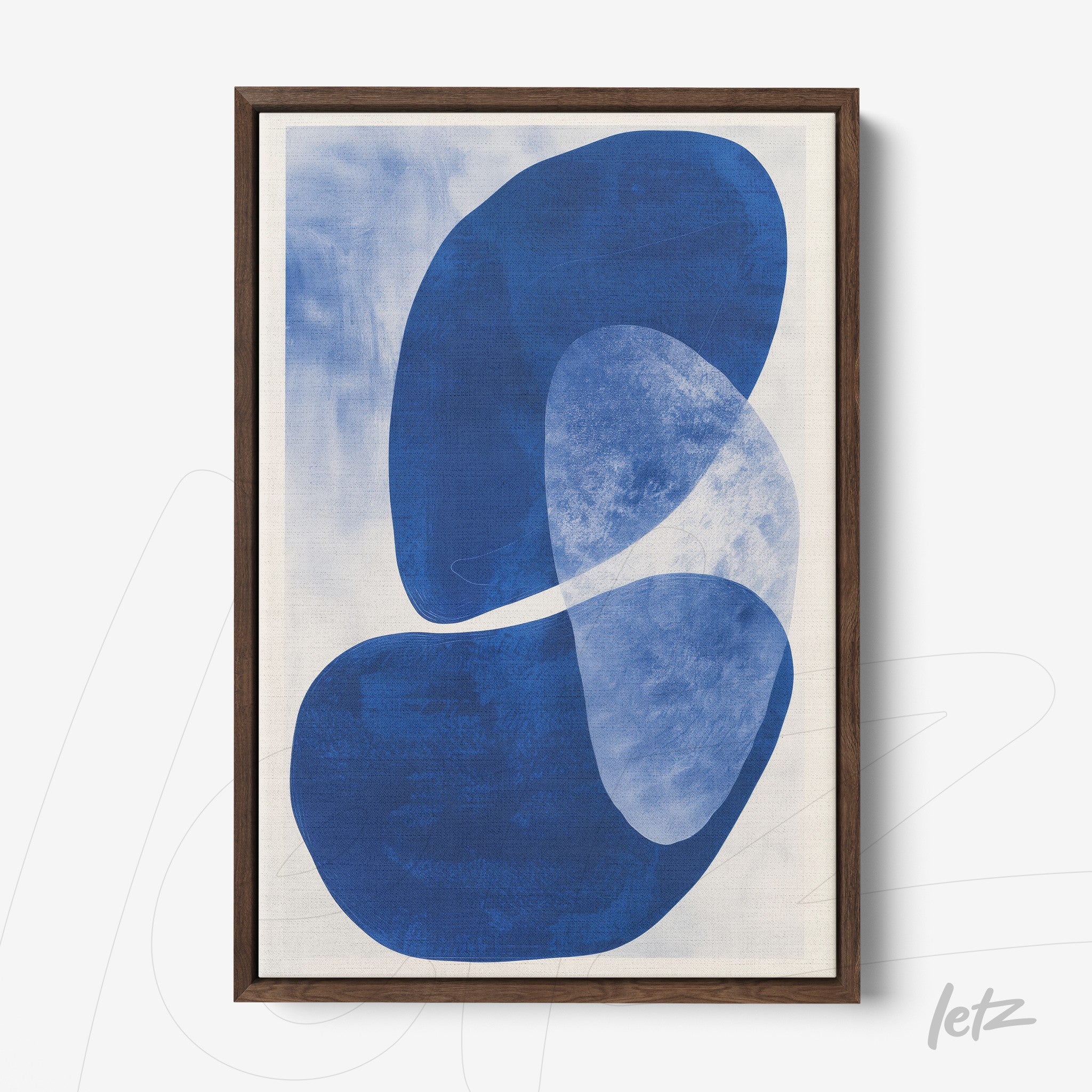 framed abstract art in shades of blue with organic shapes on a light background in a dark wood frame