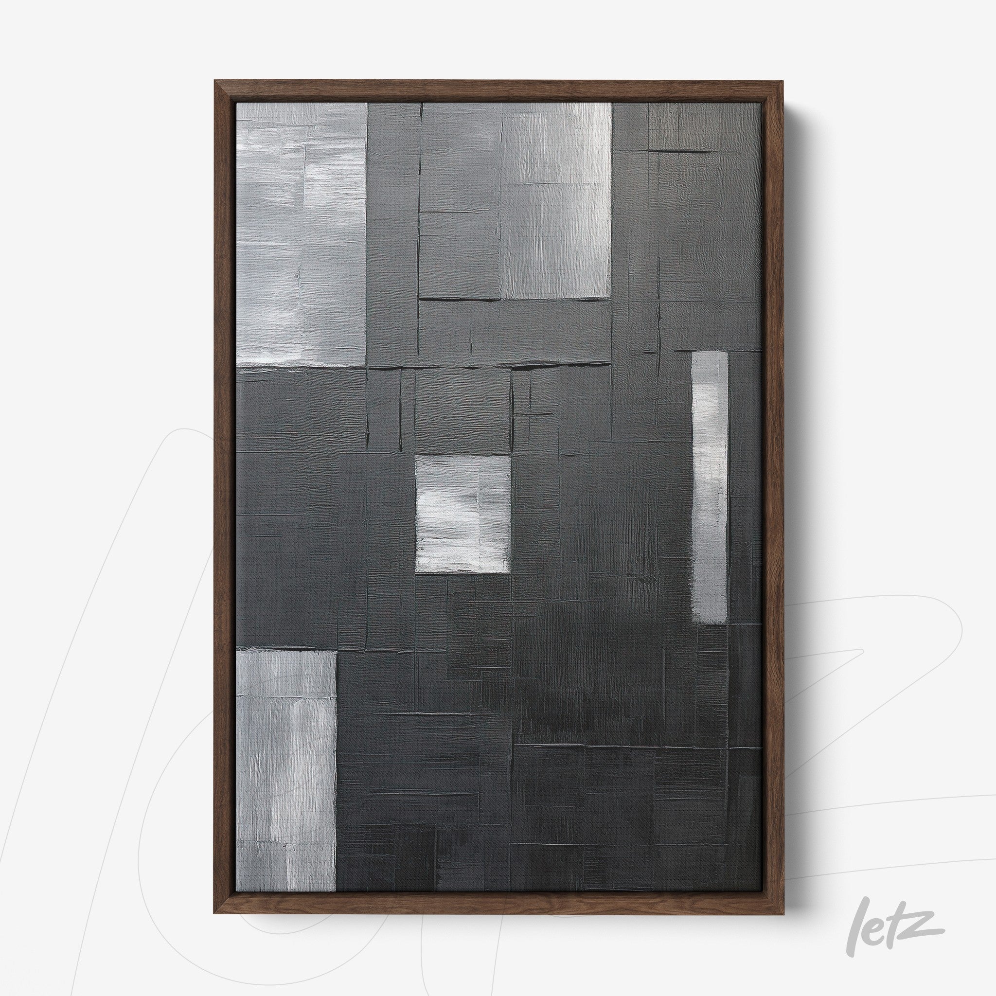 abstract wall art in shades of black and gray with textured surface, dark wood frame