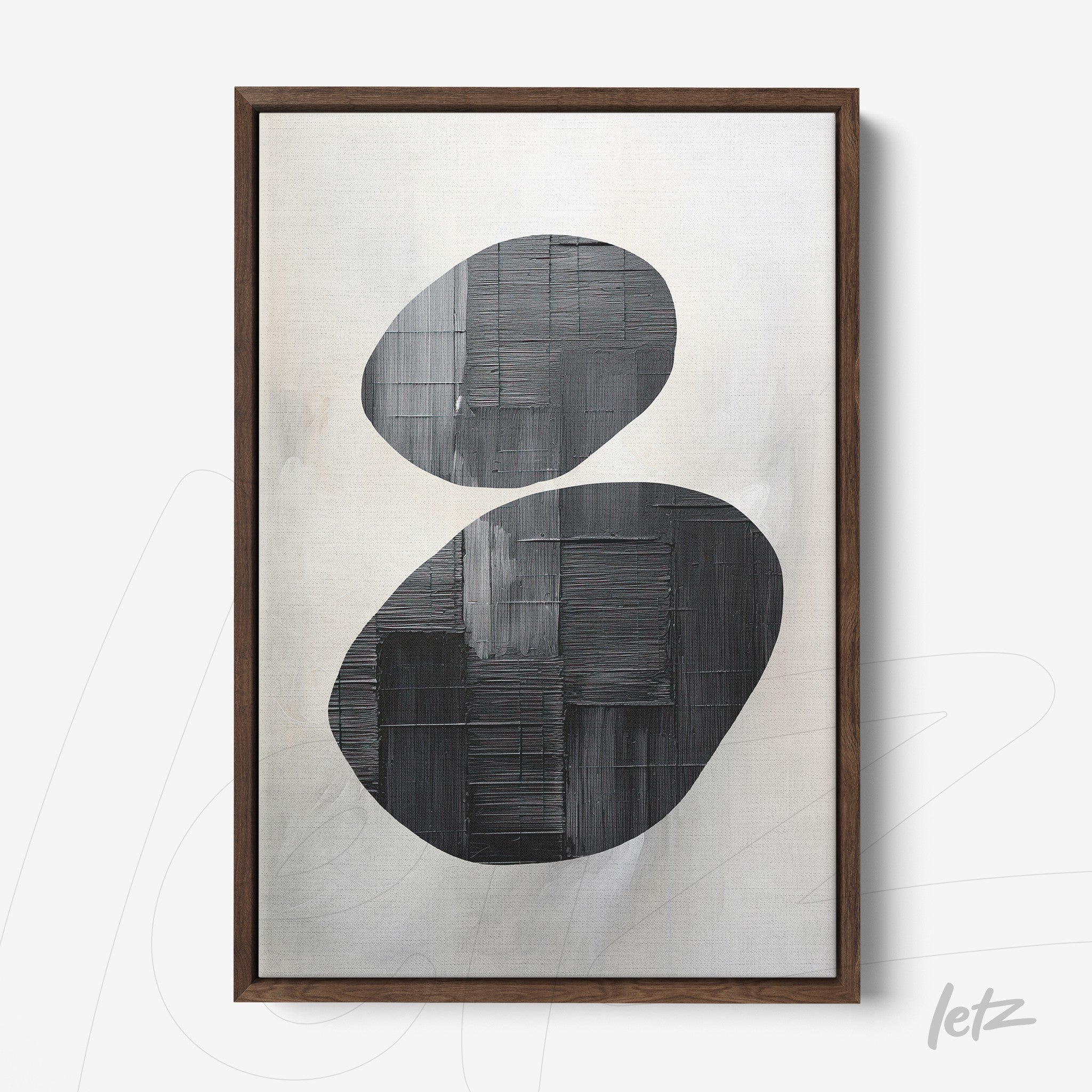 framed abstract art featuring black and gray shapes with a dark wooden frame