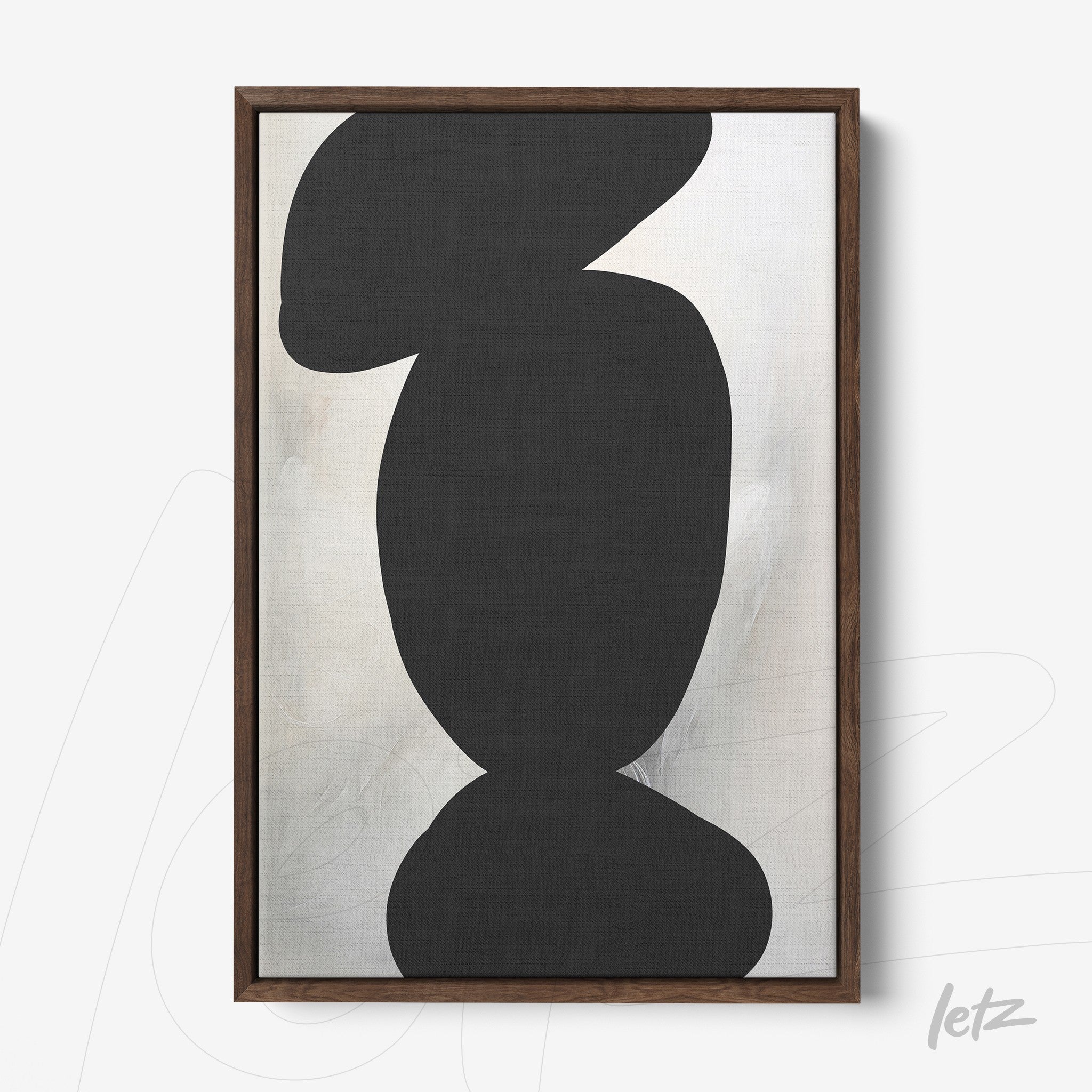 framed wall art featuring black and white abstract shapes with organic forms in a dark wood frame