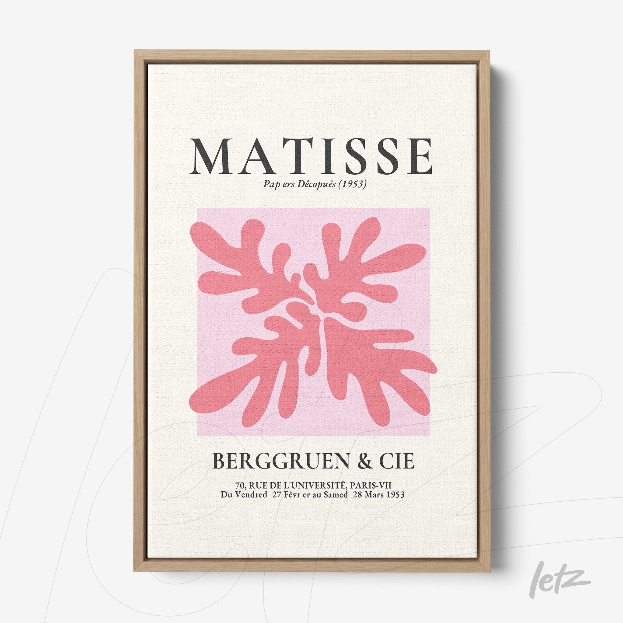 framed modern art featuring pink leaves on a light background with a light wood frame