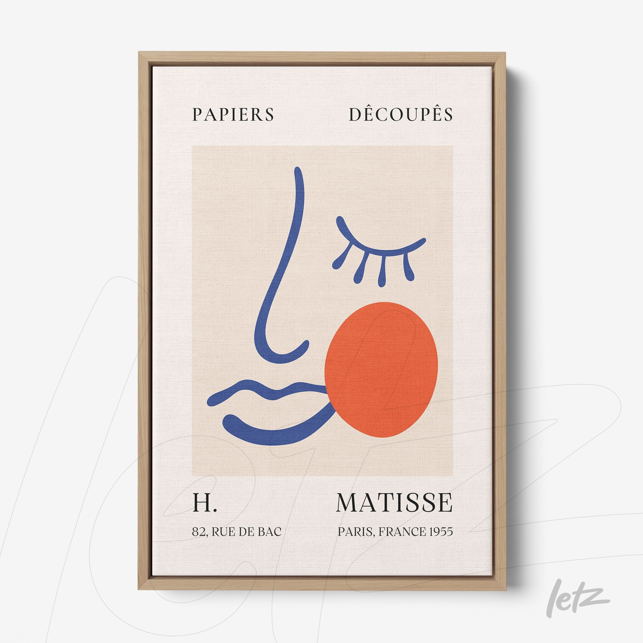 framed contemporary art print featuring an abstract face design with colorful shapes in a light wood frame