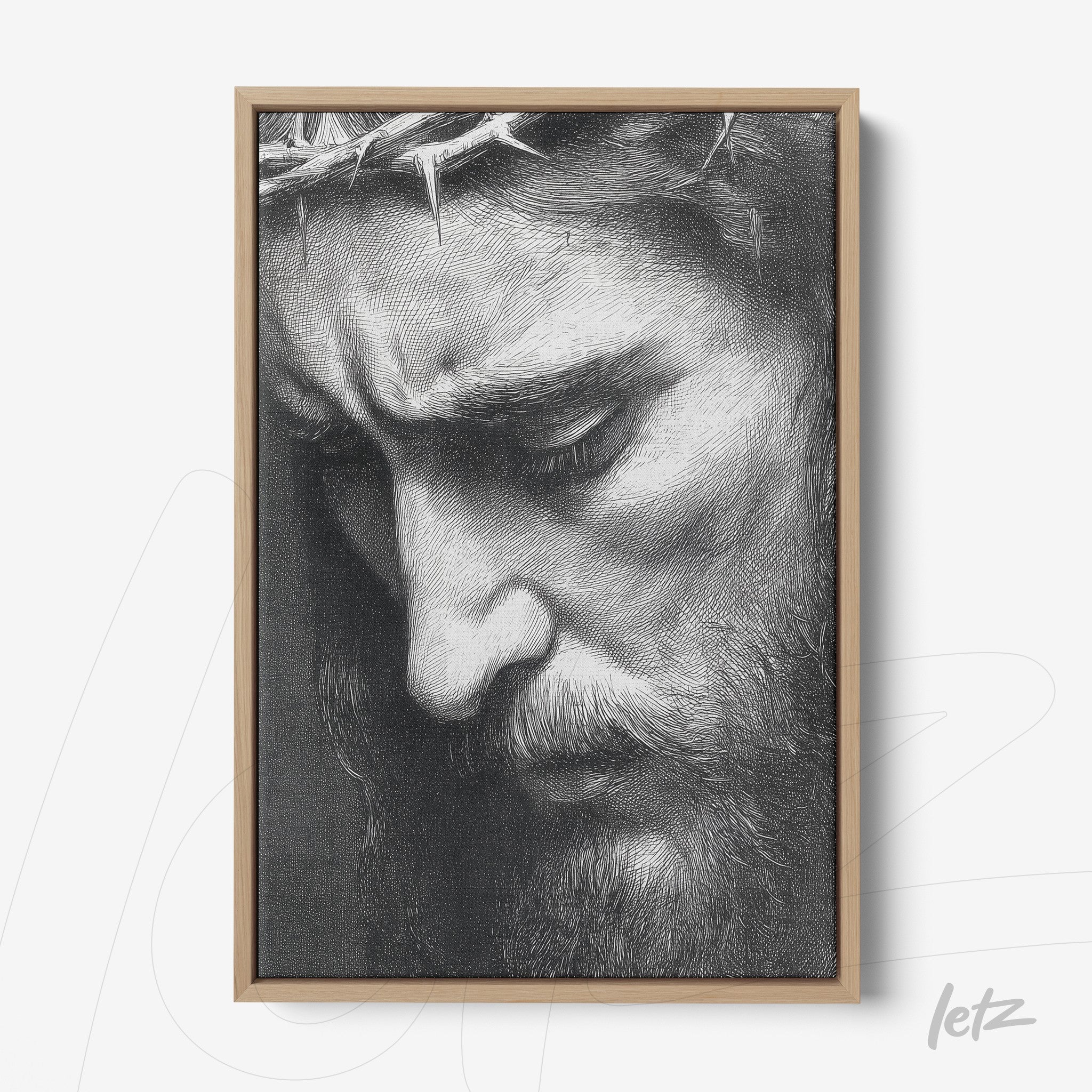 framed artwork in black and white of a man's face with a crown of thorns in light wood frame