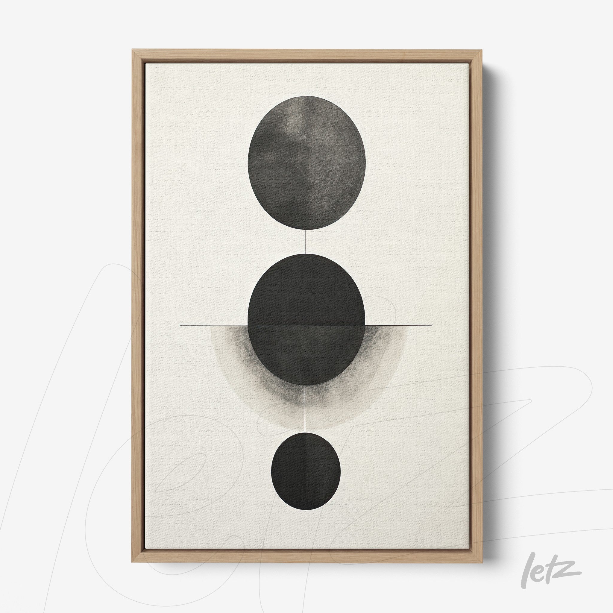 abstract wall art featuring black and white circles of varying sizes in light wood frame