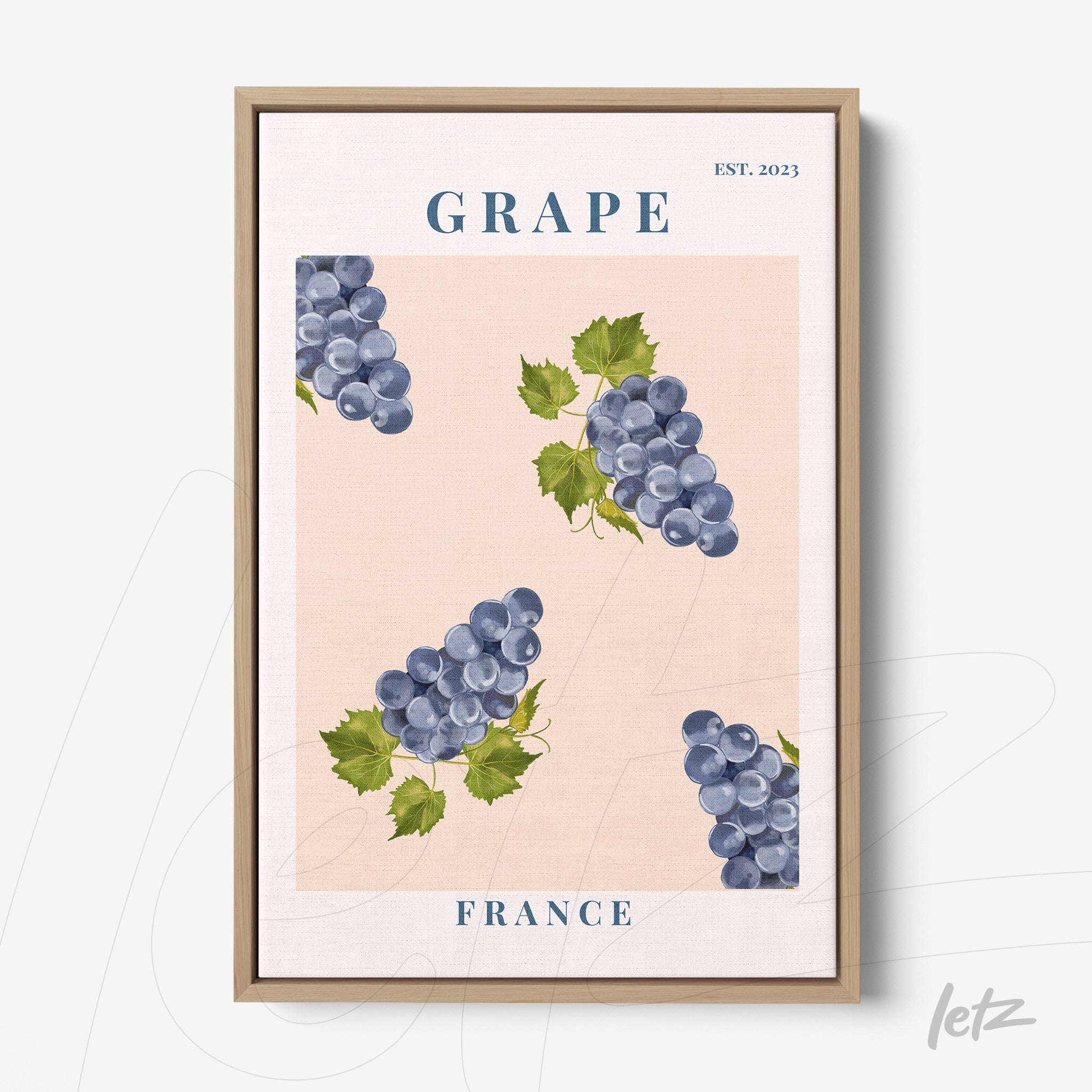 framed artwork featuring blue grapes on a pink background with a light wood frame
