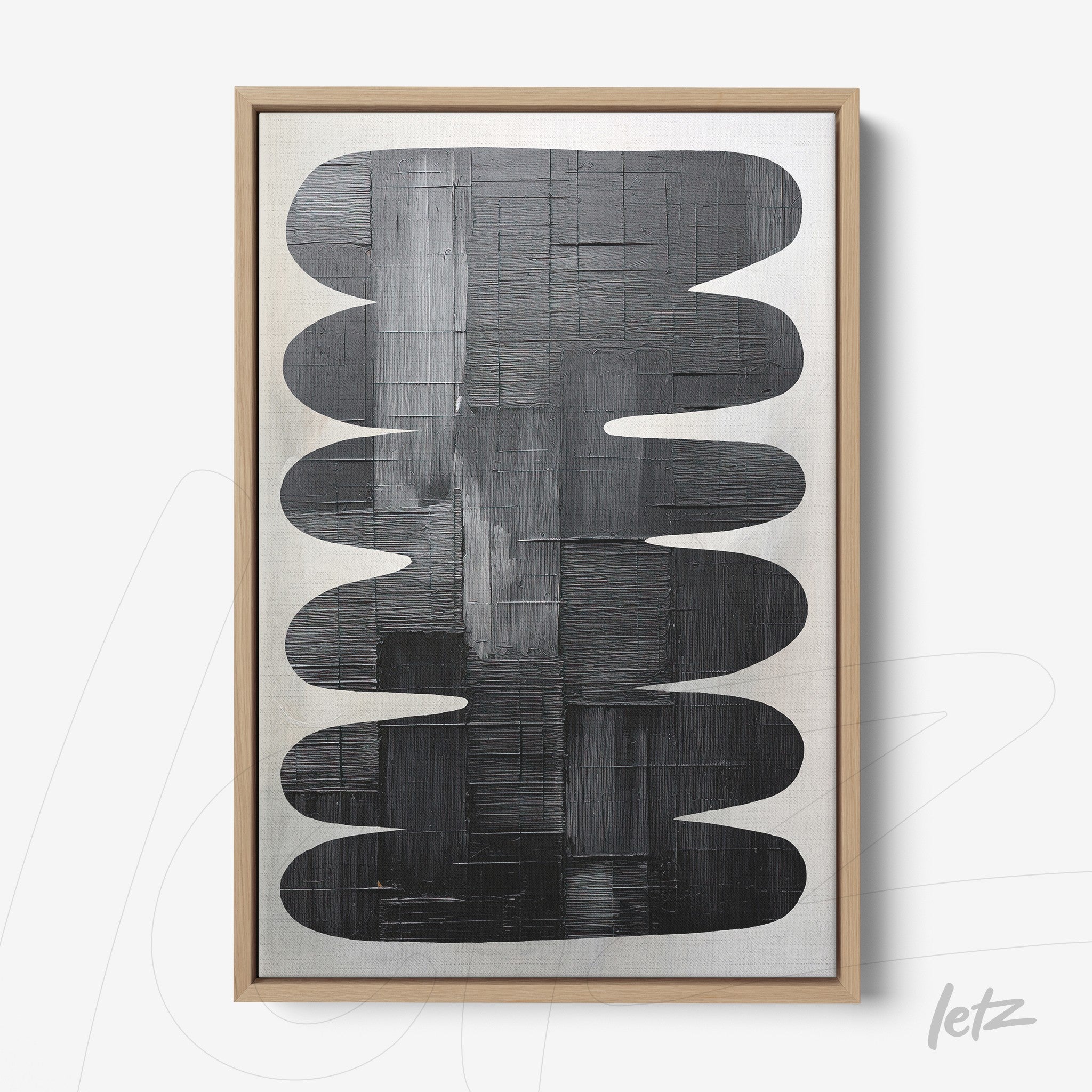 abstract canvas art featuring oval shapes in black on a light background, framed in light wood