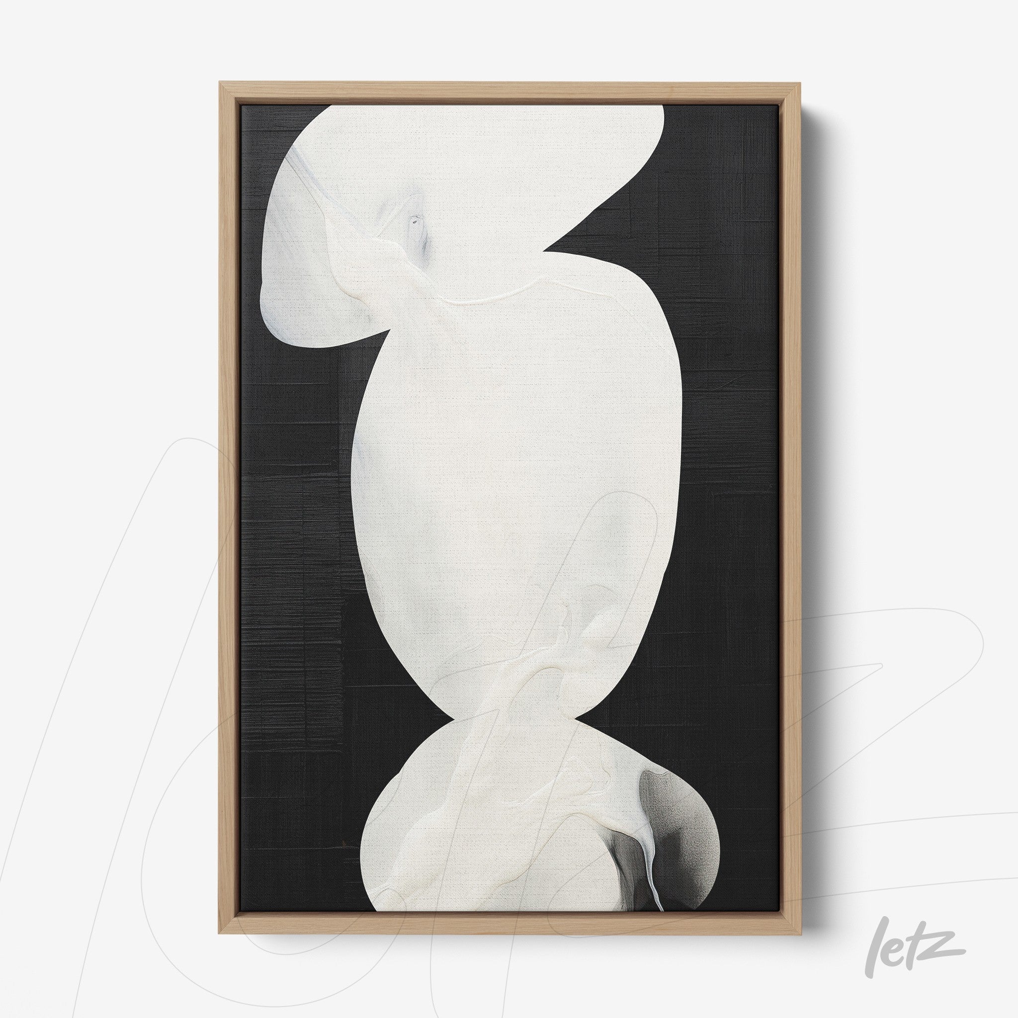 abstract wall art in shades of white on a black background with a light wood frame