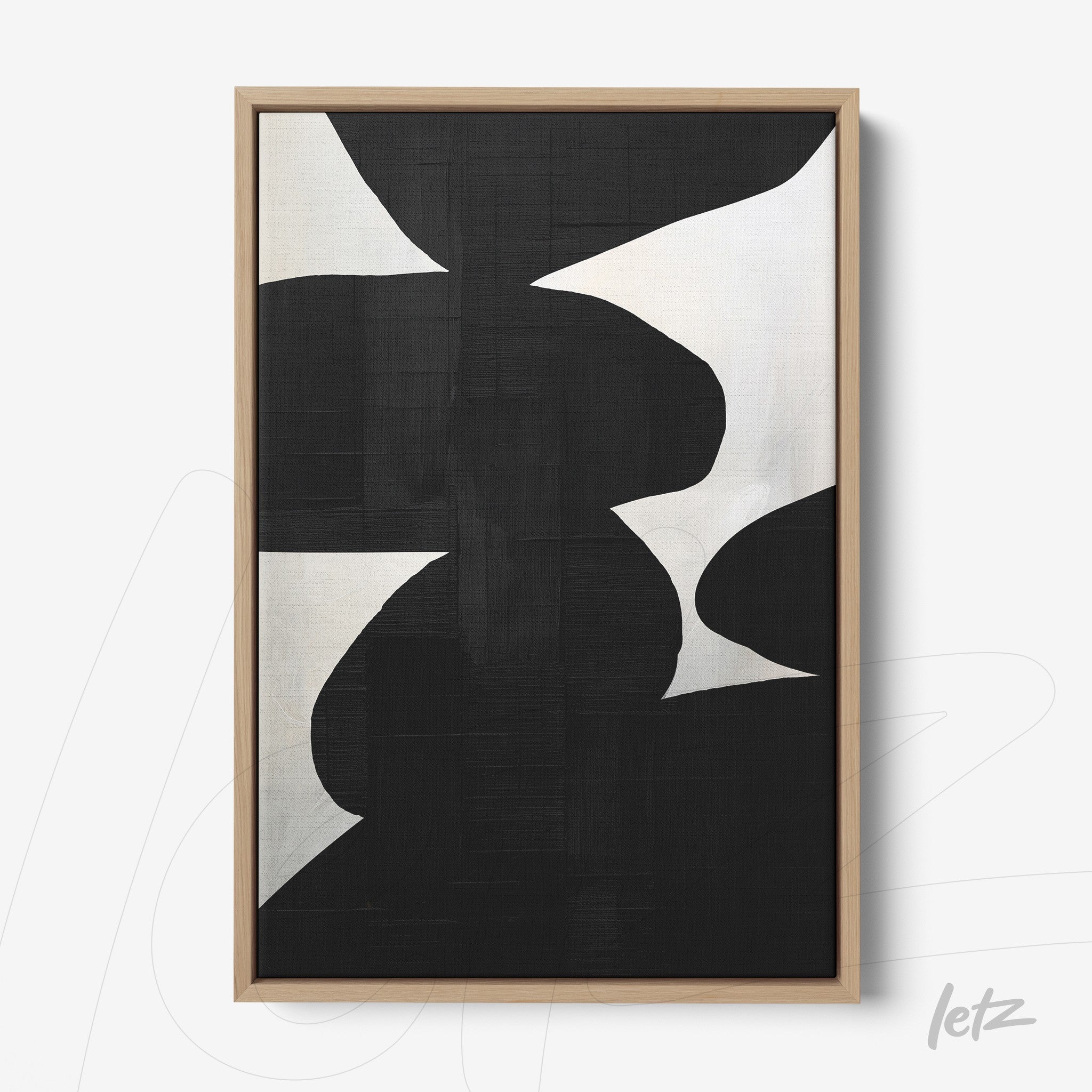 modern wall art featuring abstract black and white shapes with light wood frame