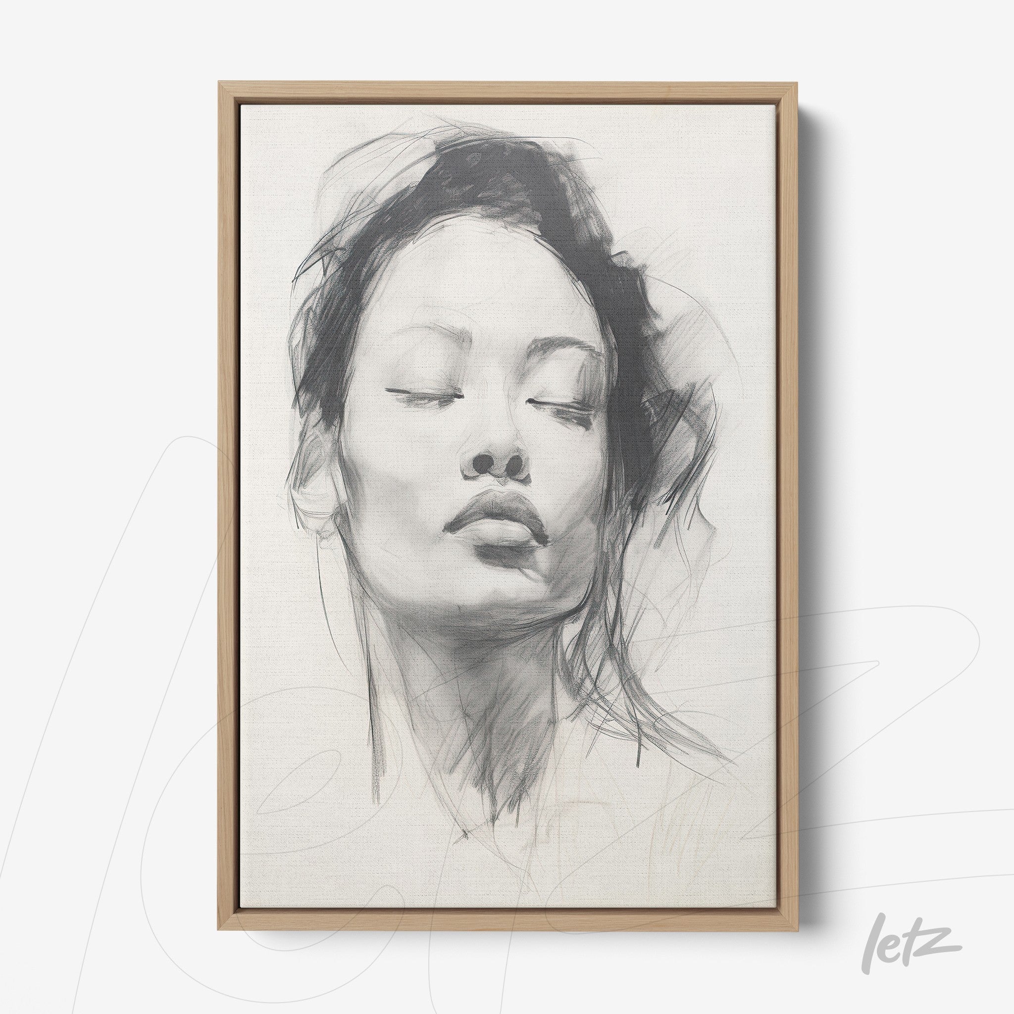 framed artwork featuring a gray-toned portrait of a serene woman with a light wood frame