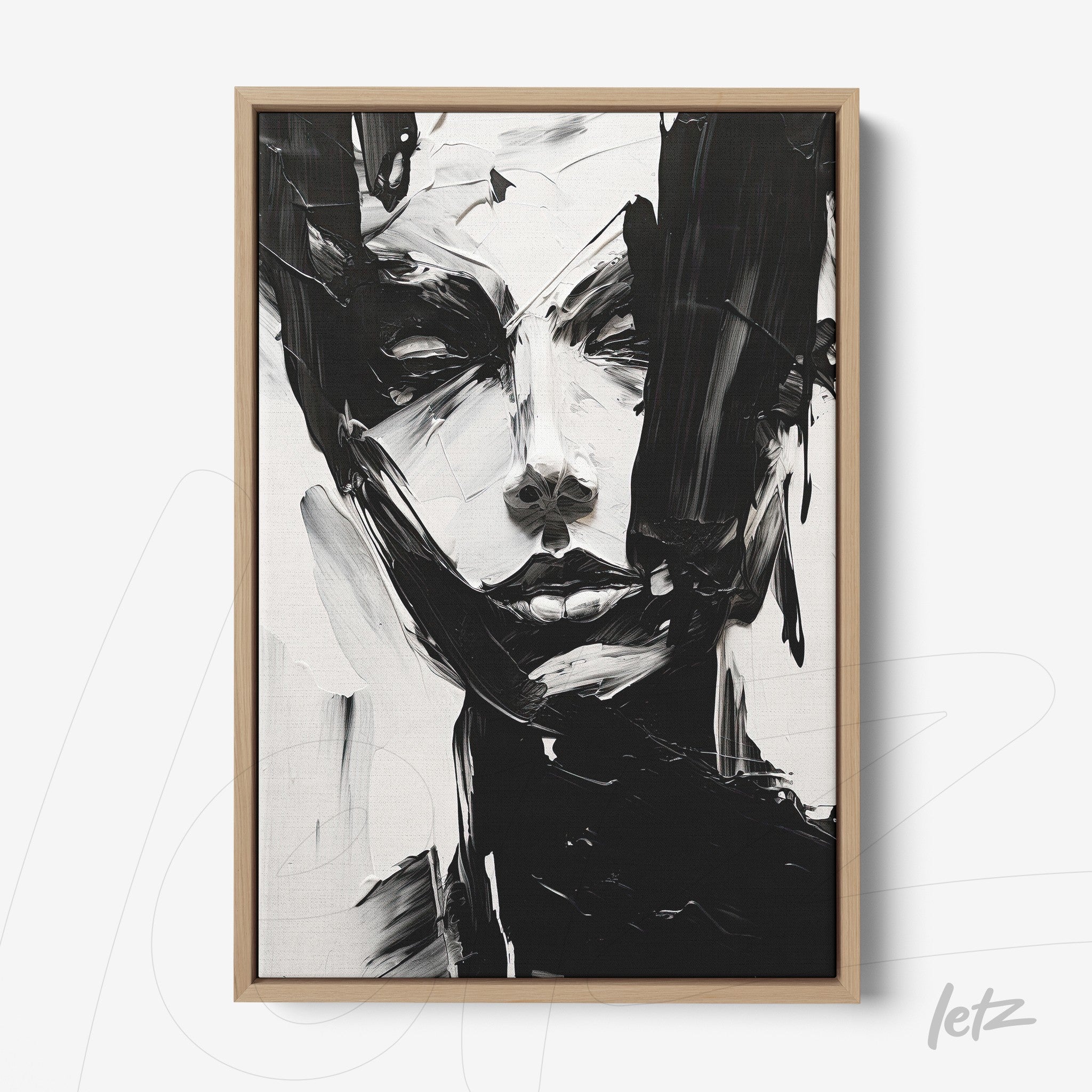 canvas wall art featuring an abstract black and white portrait of a woman framed in light wood