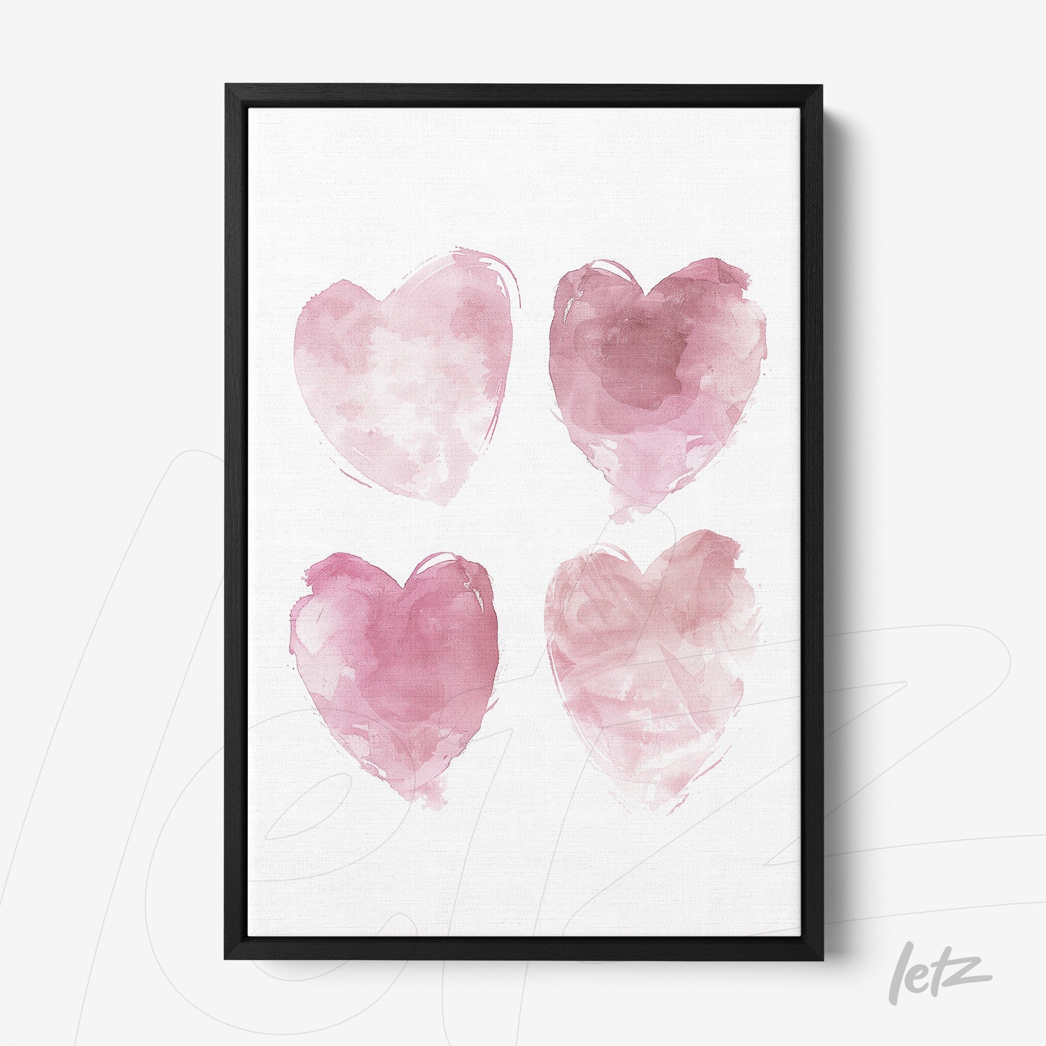 framed watercolor art featuring four pink hearts in black frame