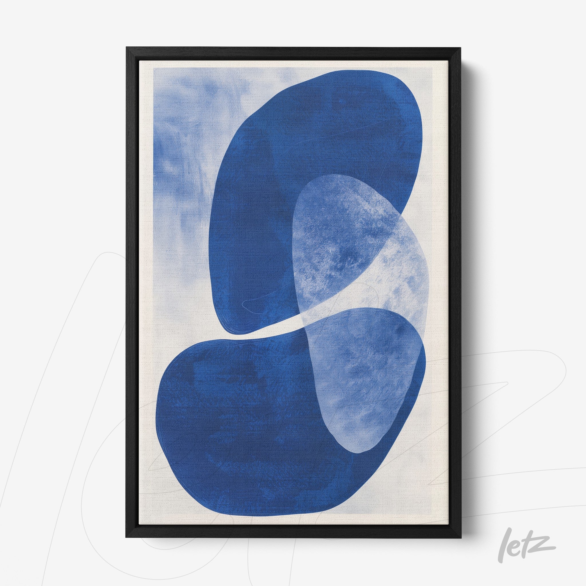 framed abstract art piece in shades of blue with black frame