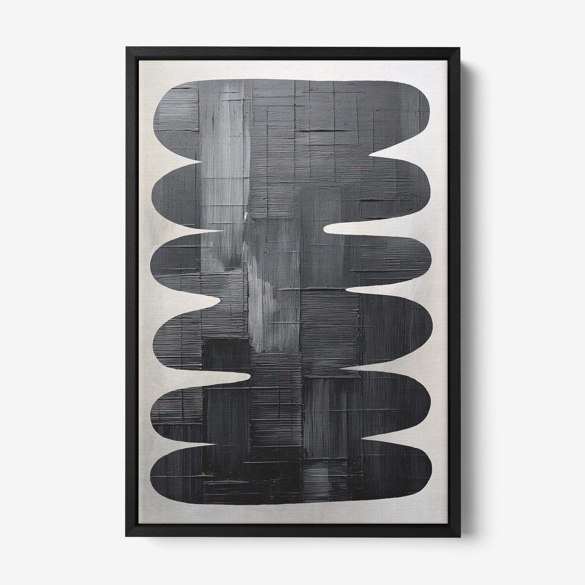 abstract wall art in black frame featuring black shapes on light background