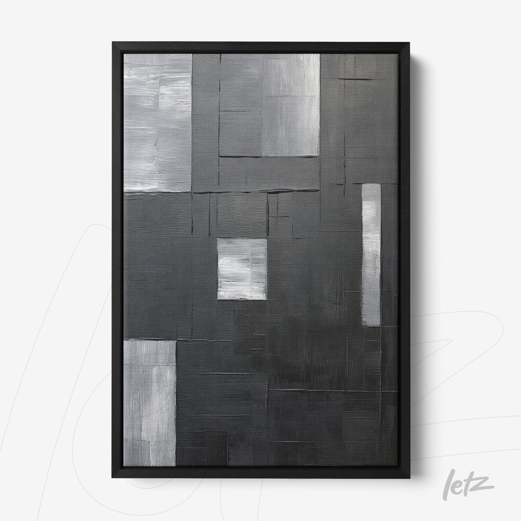 modern wall art in shades of black, gray, and silver with a thin black frame