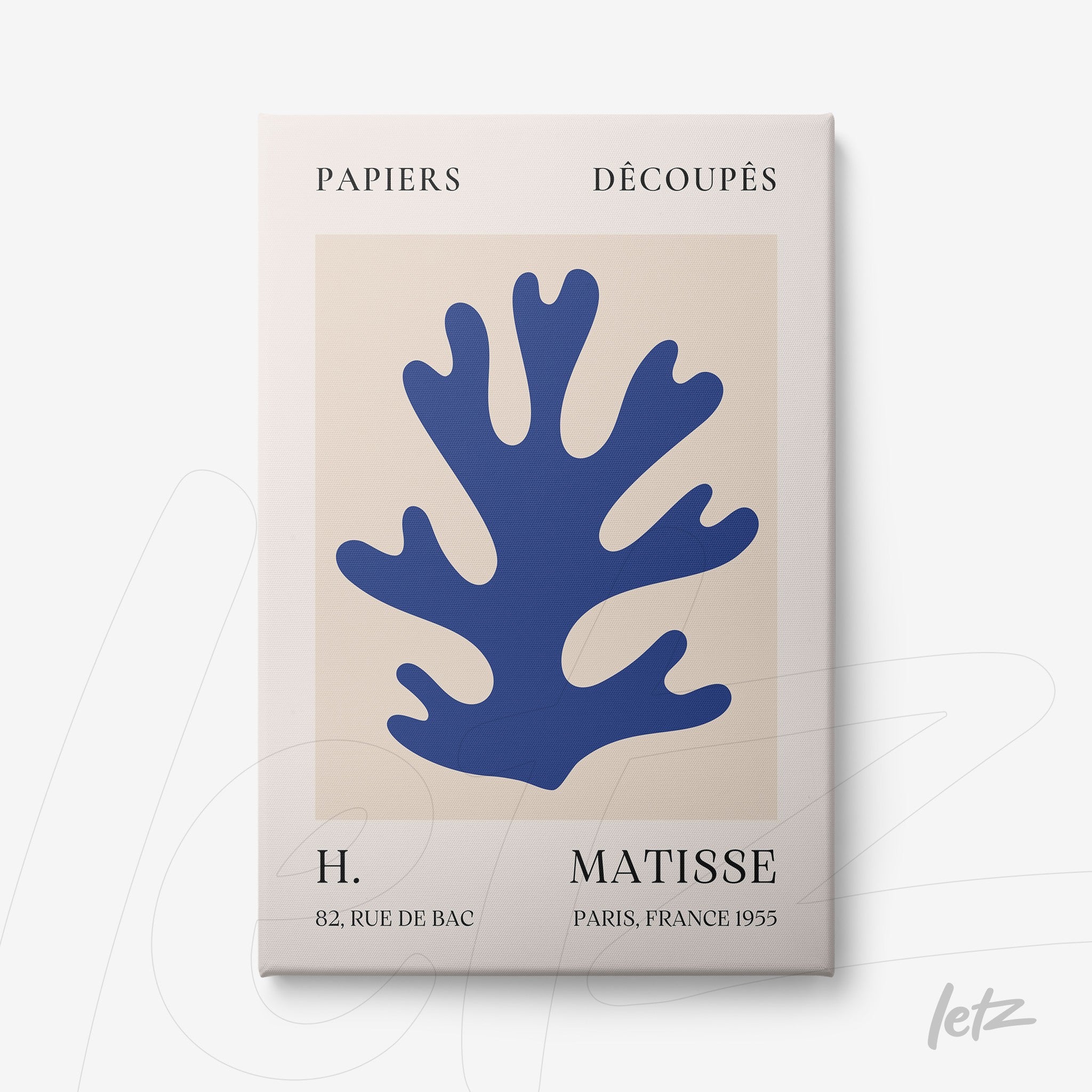 framed wall art featuring a paper cut design of a blue coral against a beige background in a minimalist style