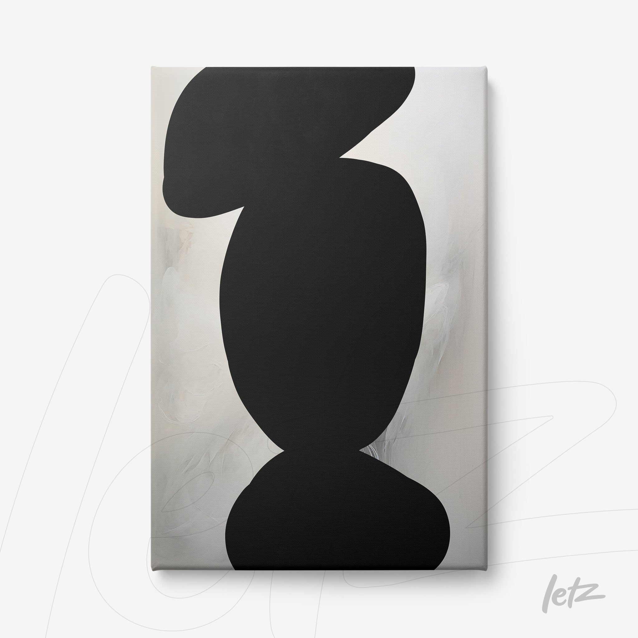 canvas art featuring abstract black shapes on a textured cream background