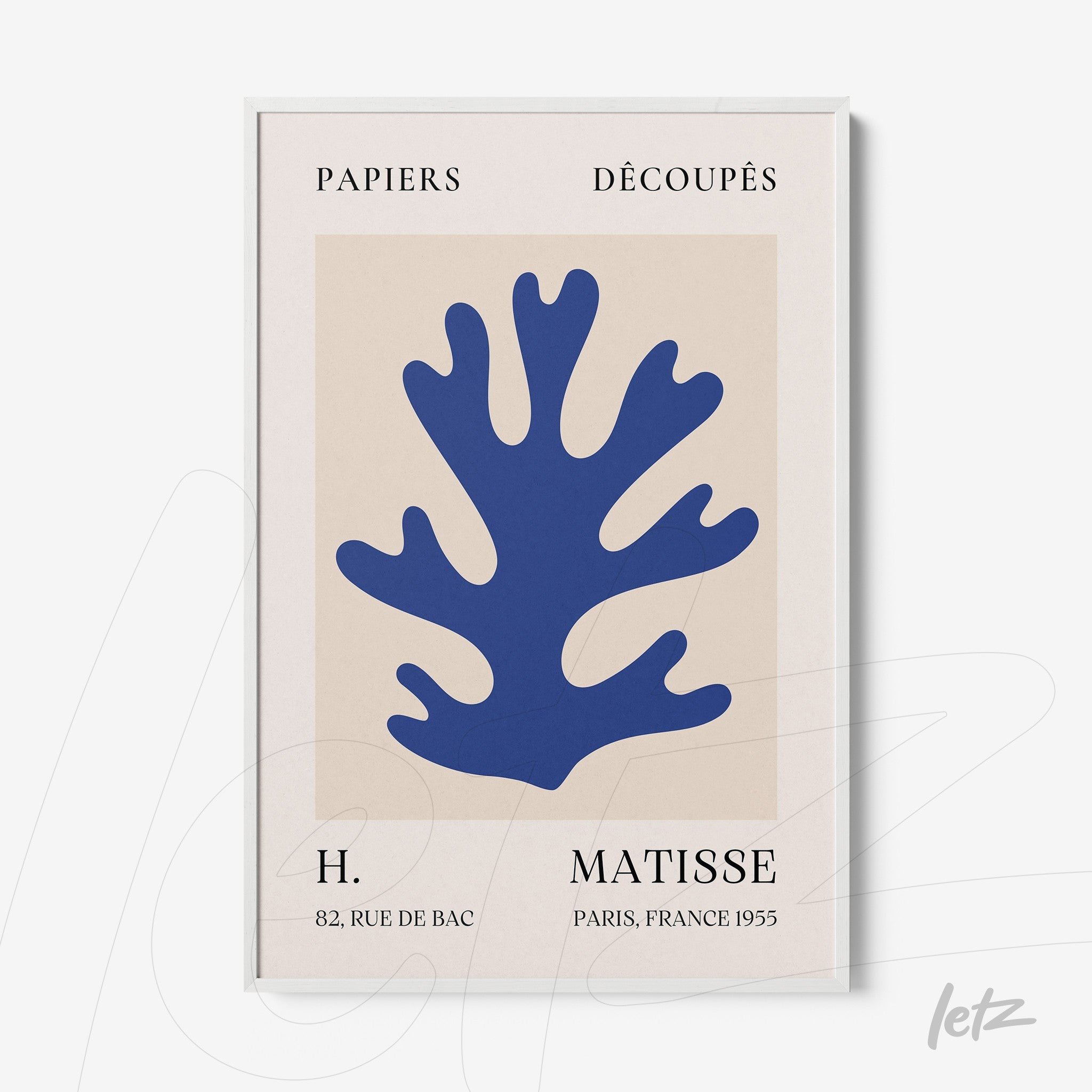 abstract wall art featuring blue cut-out plant shape on light background with white frame