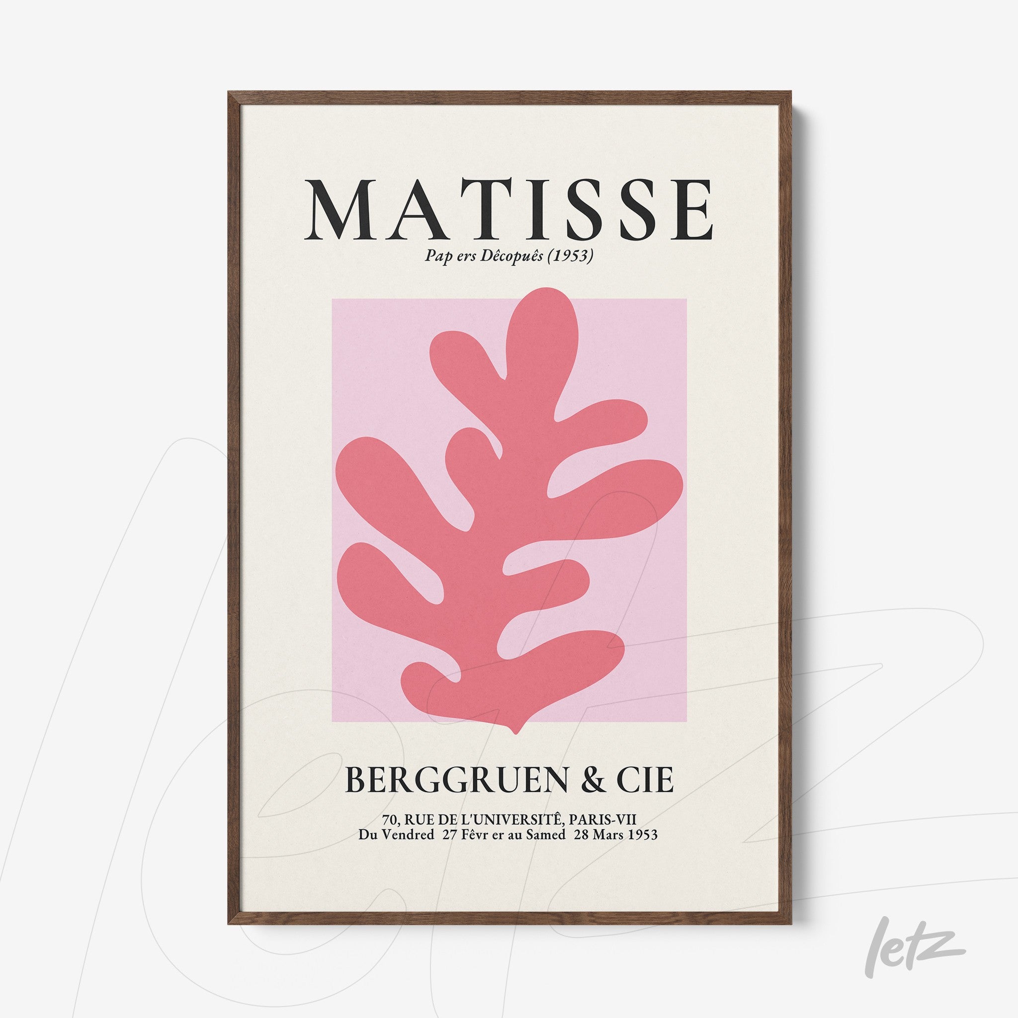 framed wall art featuring modern abstract leaf shapes in pink on a light background with a dark wood frame