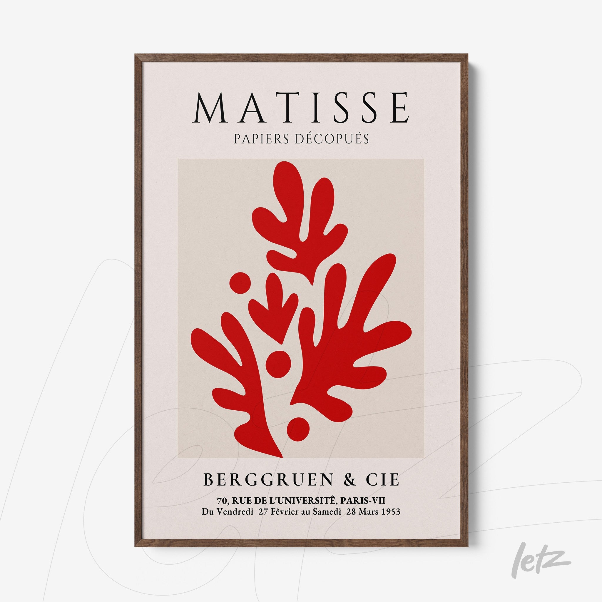 framed abstract wall art featuring layered red shapes on a light background with dark wood frame