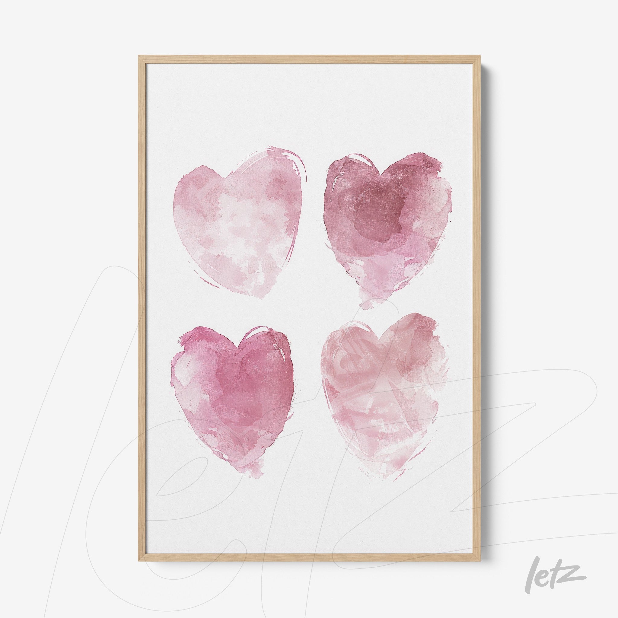 framed art with four pink watercolor hearts in light wooden frame