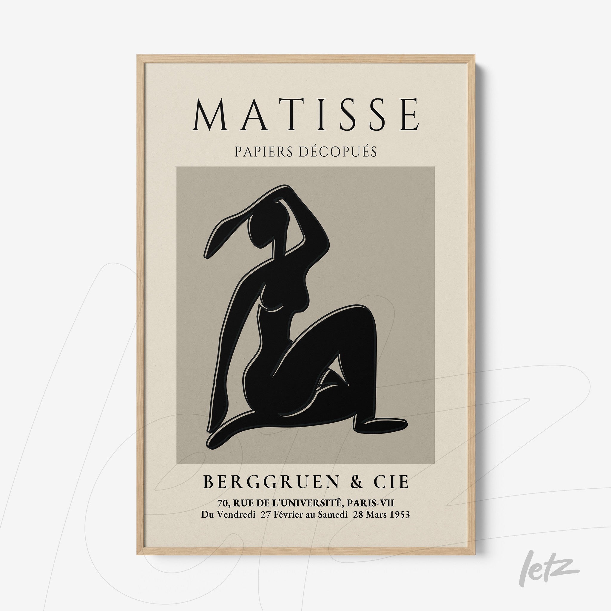 framed wall art featuring a black and white silhouette of a seated woman with a light wood frame