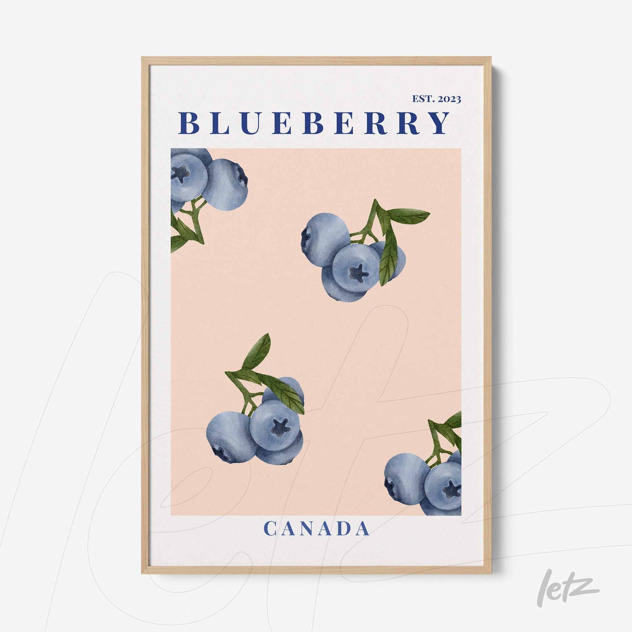 framed art featuring blueberries on a light pink background with a light wood frame
