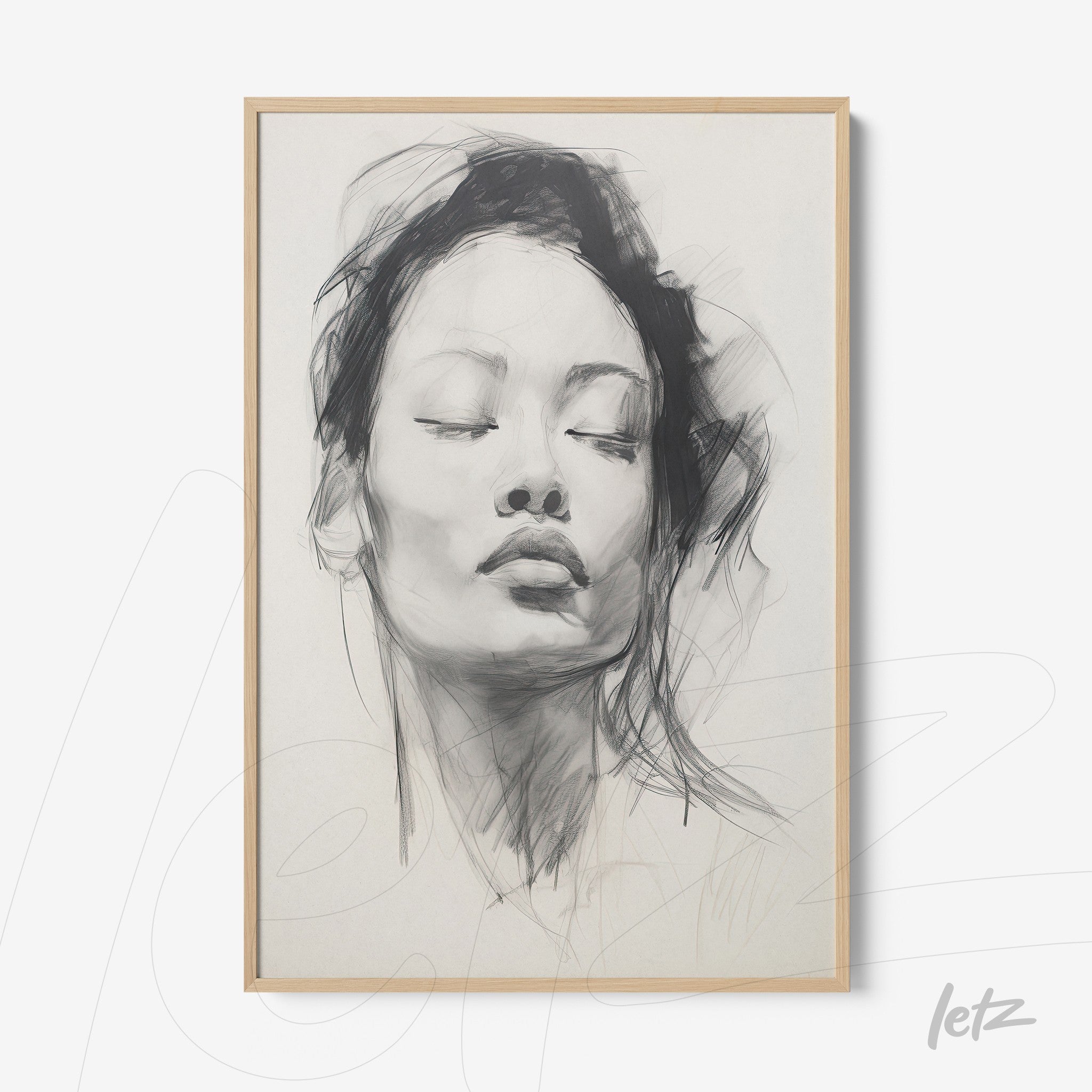 framed artwork featuring a black and white portrait of a woman with a light wood frame