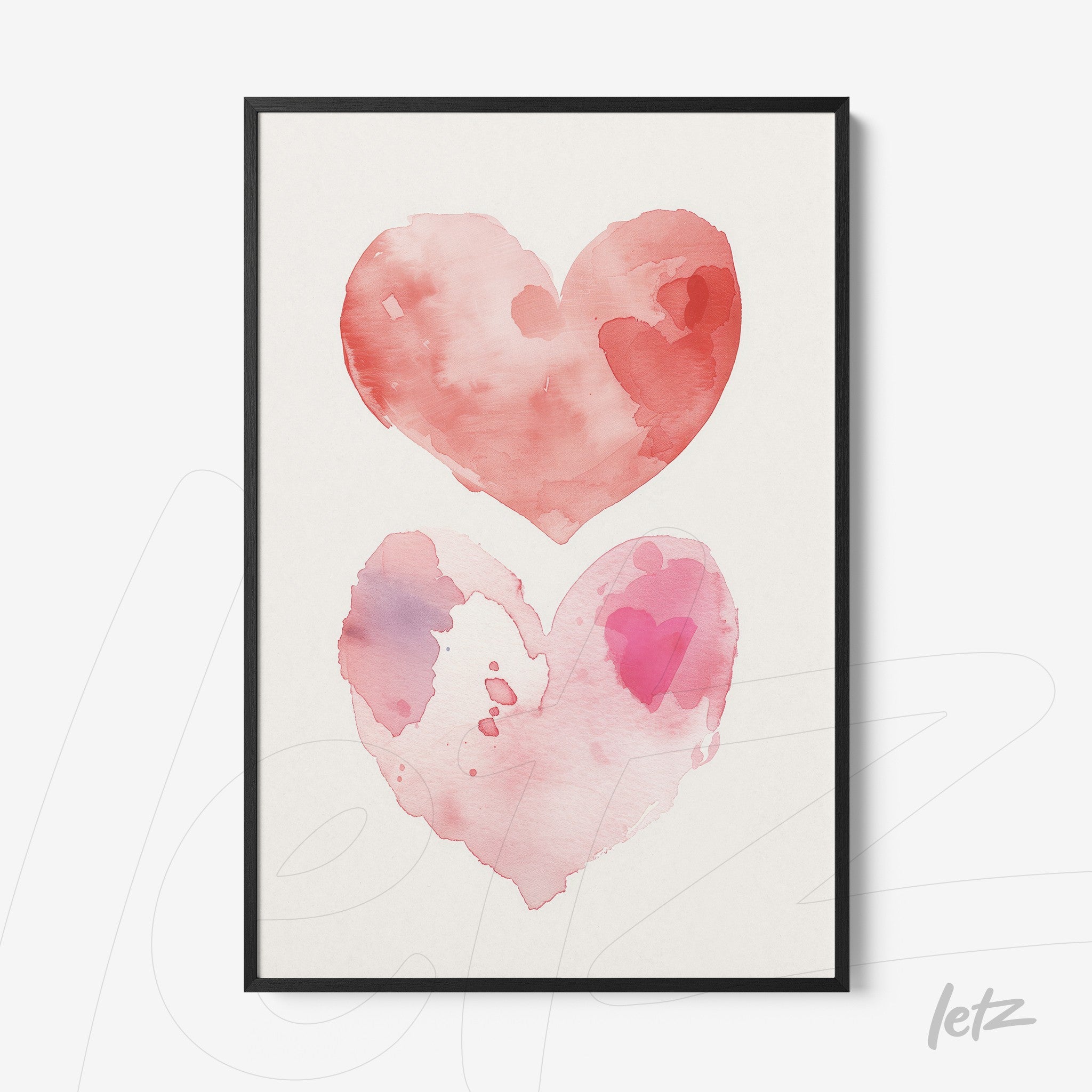 framed artwork of watercolor hearts in shades of pink and red with black frame